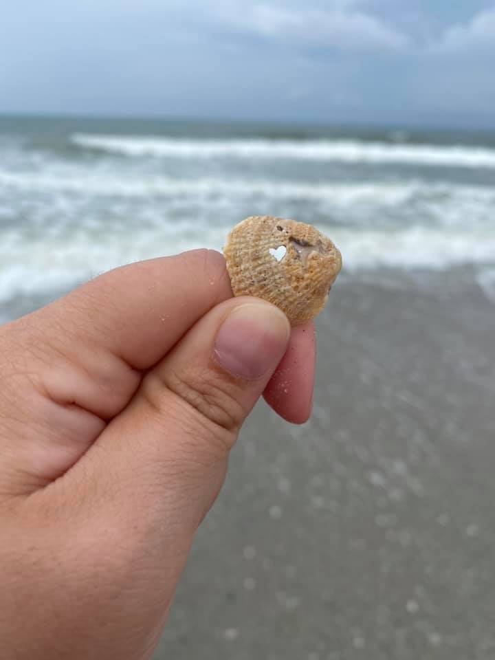 Finding a heart-shaped seashell at Myrtle Beach