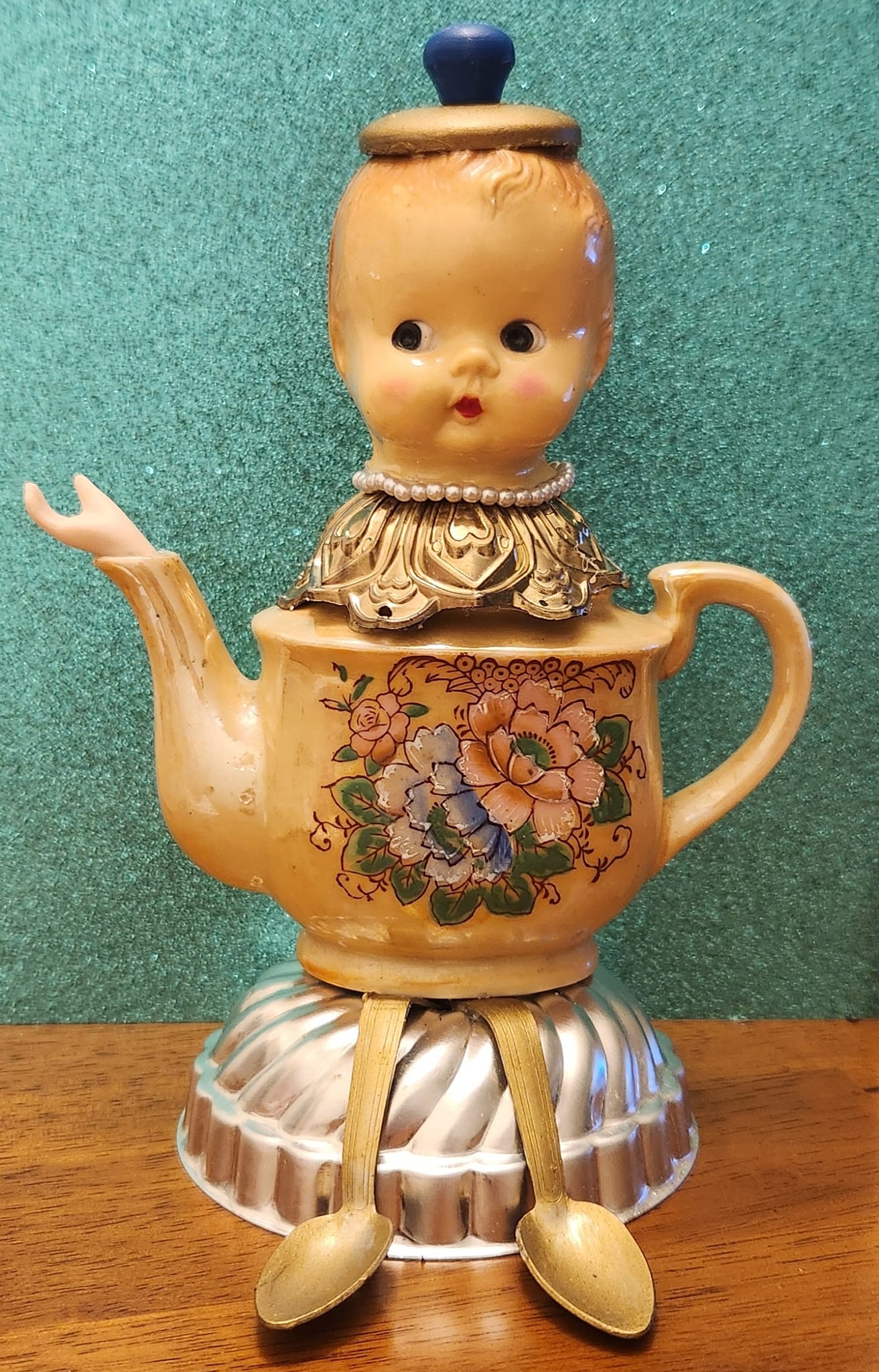 Tea pot art made from vintage doll parts
