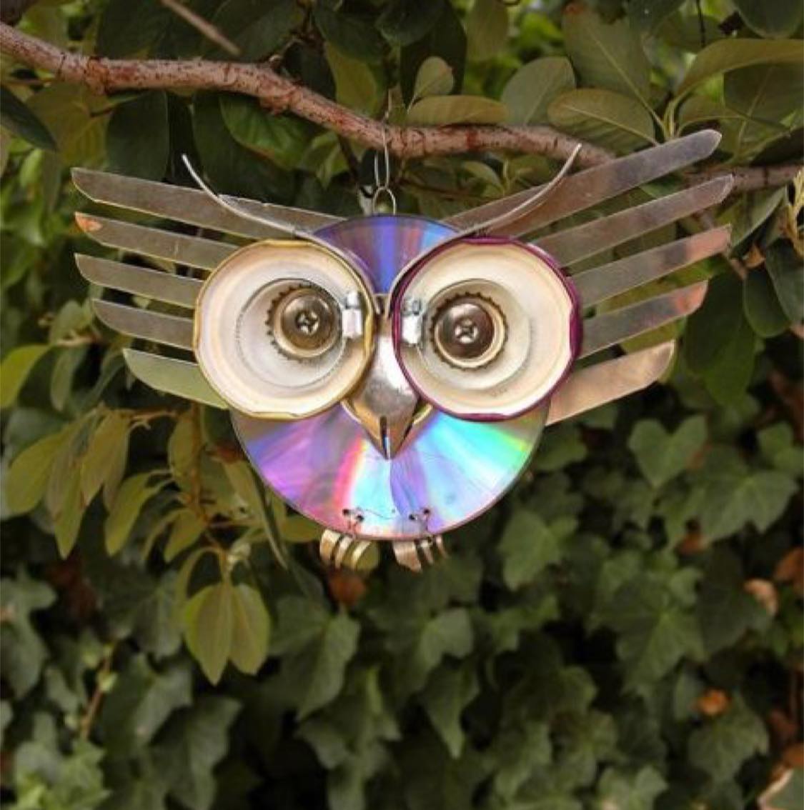 Owl art made from kitchen items and CDs