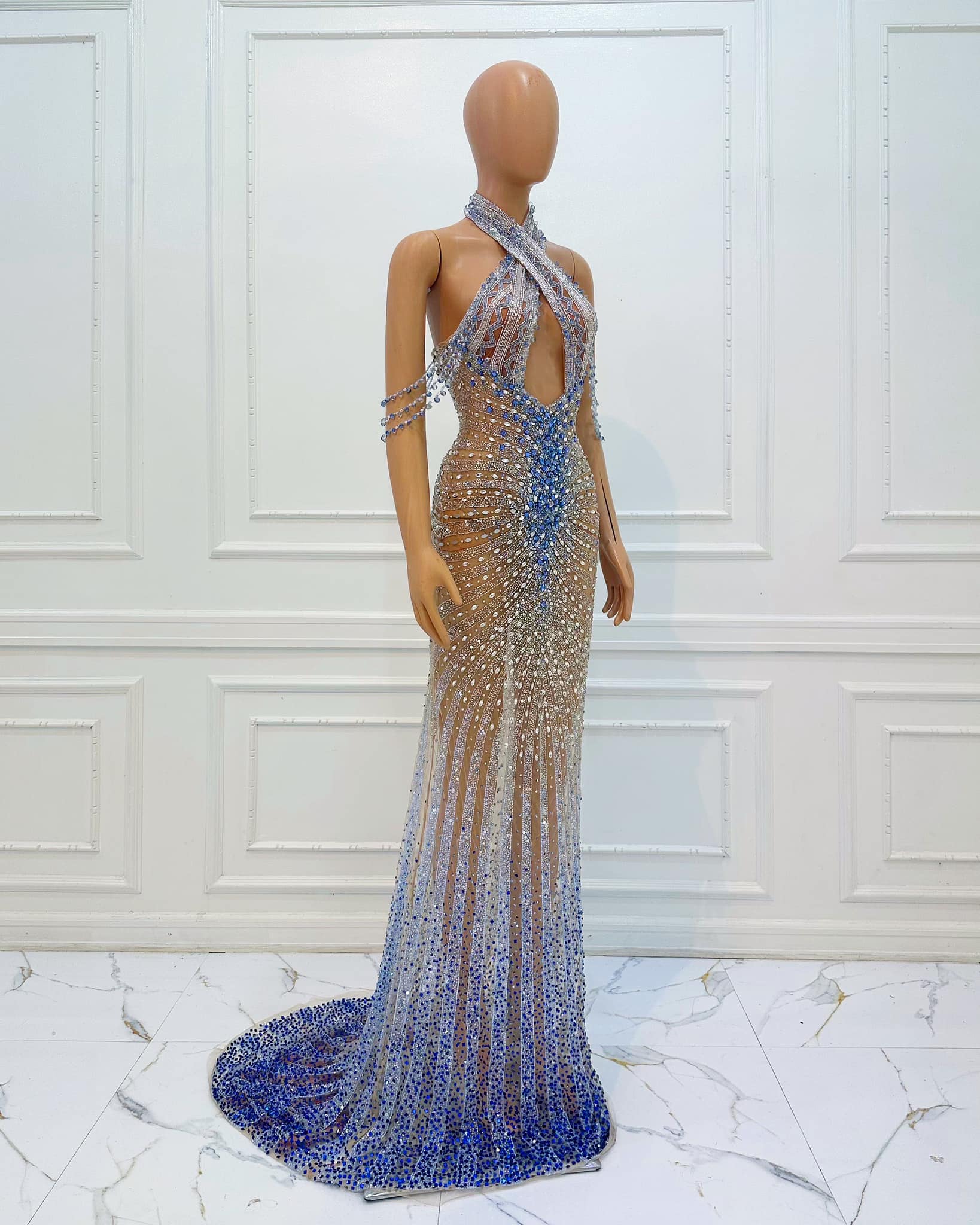 ice blue queen sequin dress This enthralling gown by Rian Fernandez demands the spotlight with its commanding halter neckline that boldly showcases the shoulders, flowing into a flawlessly tailored bodice lavishly adorned with exquisite hand UK size:12