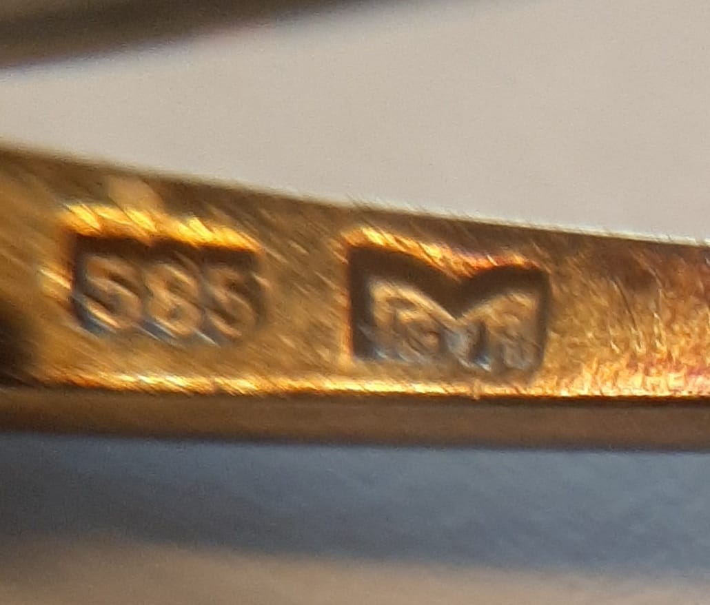 What does the stamp next to 585 mean in 14k gold?