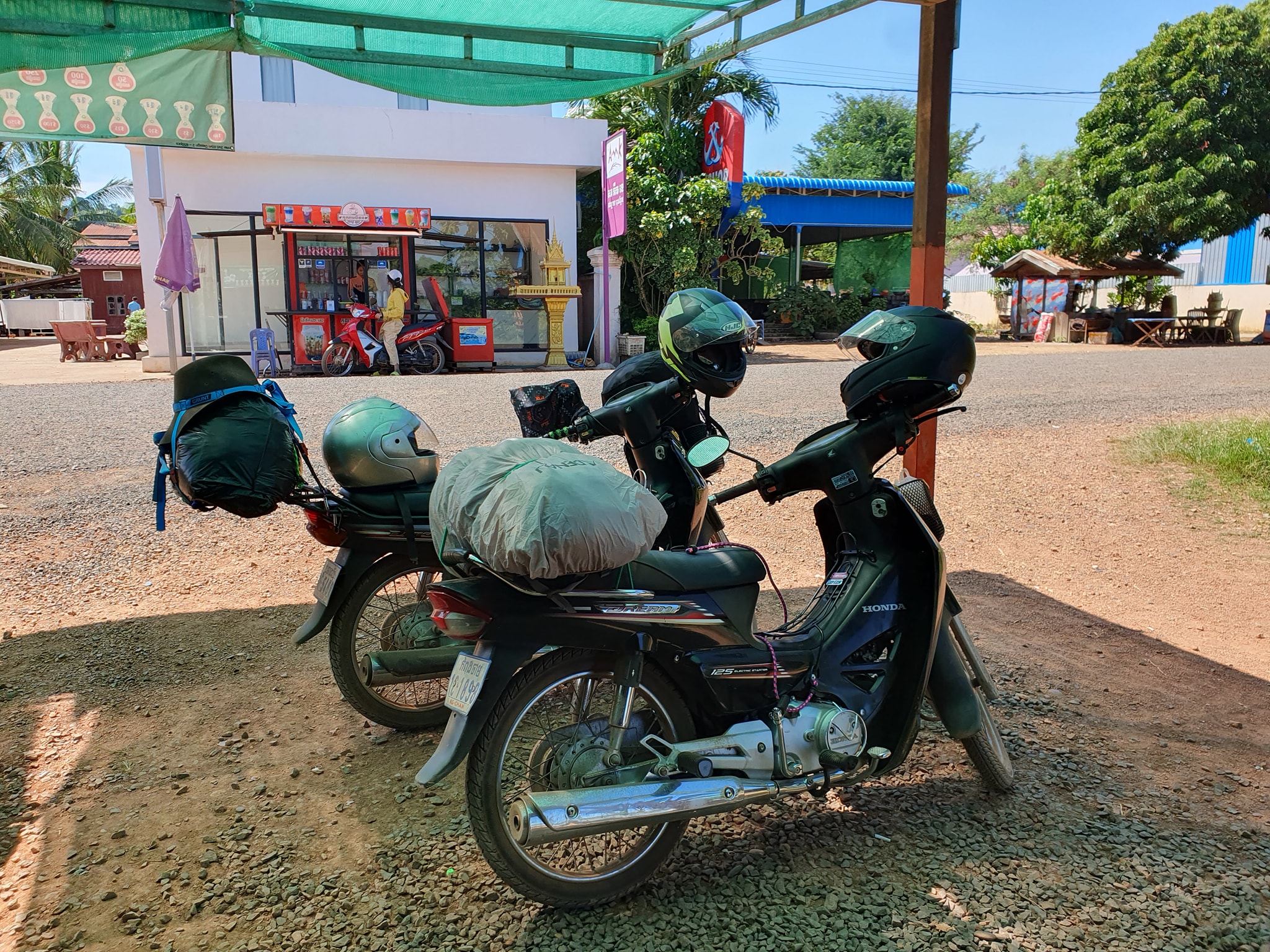 Currently riding two Khmer registered Honda Dream from Cambodia