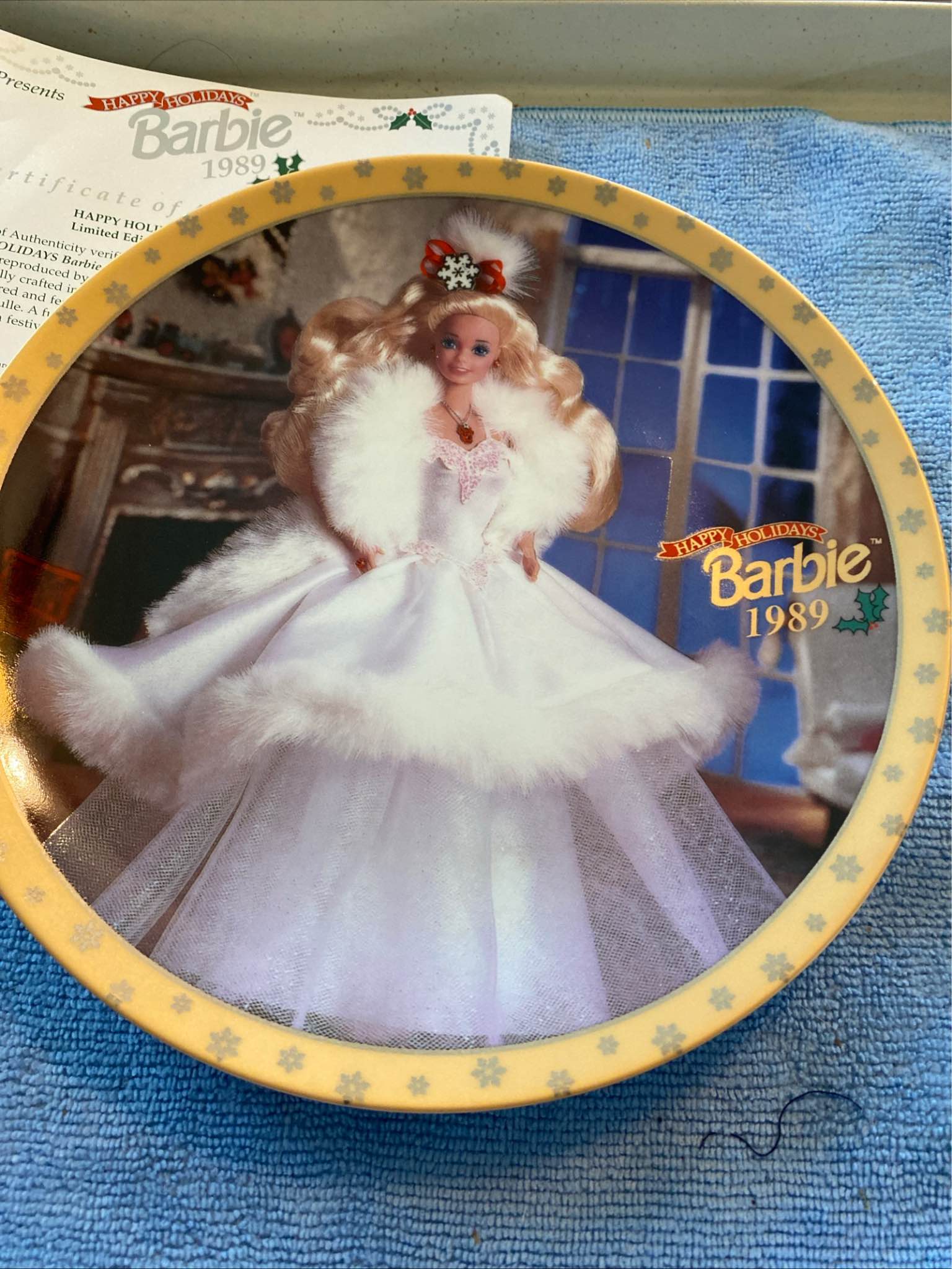 Collectible Happy Holidays Barbie 1989 Limited Edition Collectors Plate. This is plate number 23,519. Has Barbie in a beautiful white dress with faux fur. Made by Enesco. Just for decorative purposes