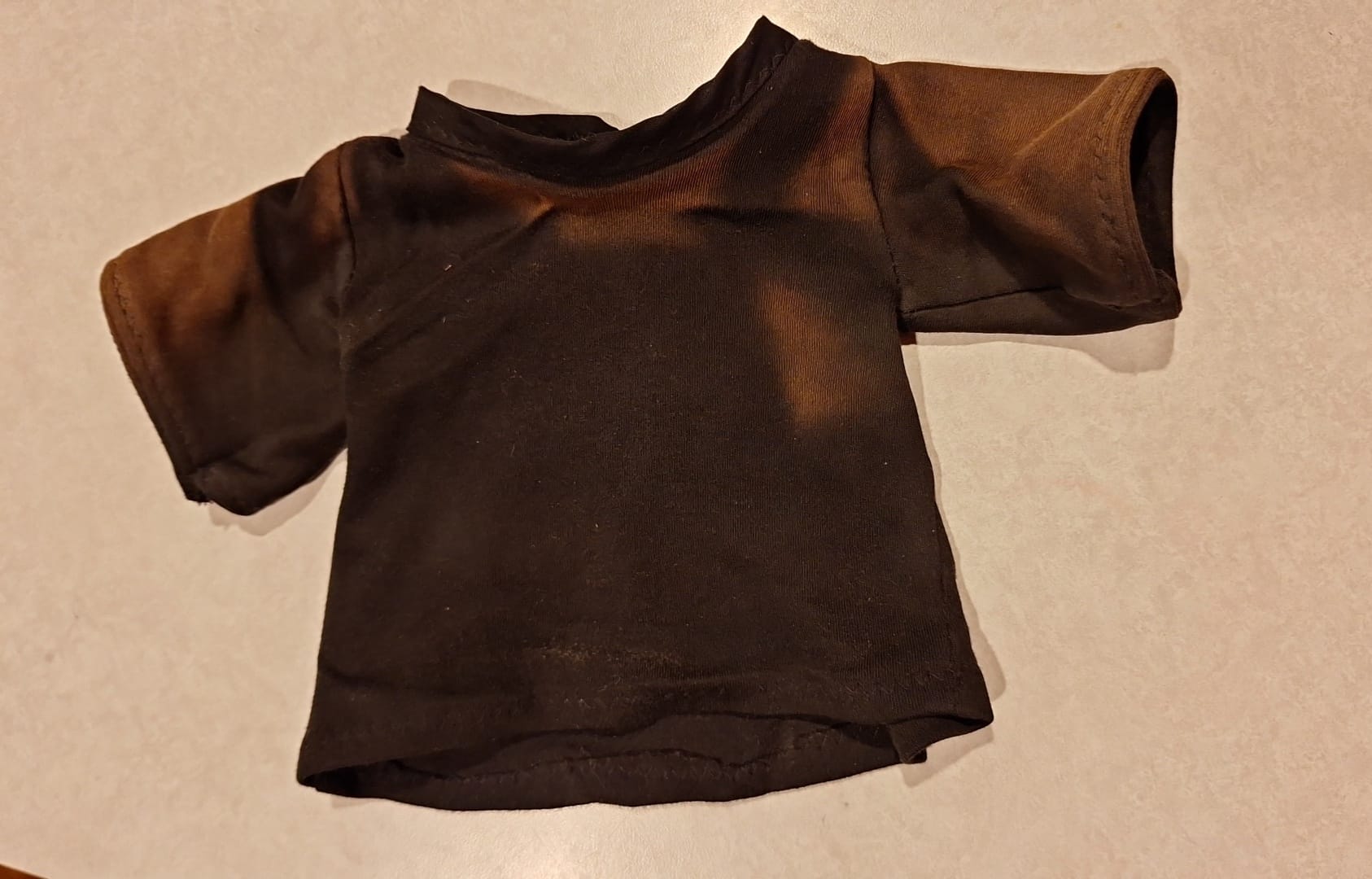 Does anyone know if I might be able to DYE this shirt black again 