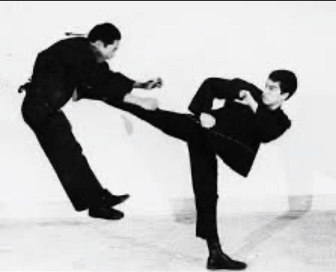 Who is Bruce Lee Side-Kicking in this photo???