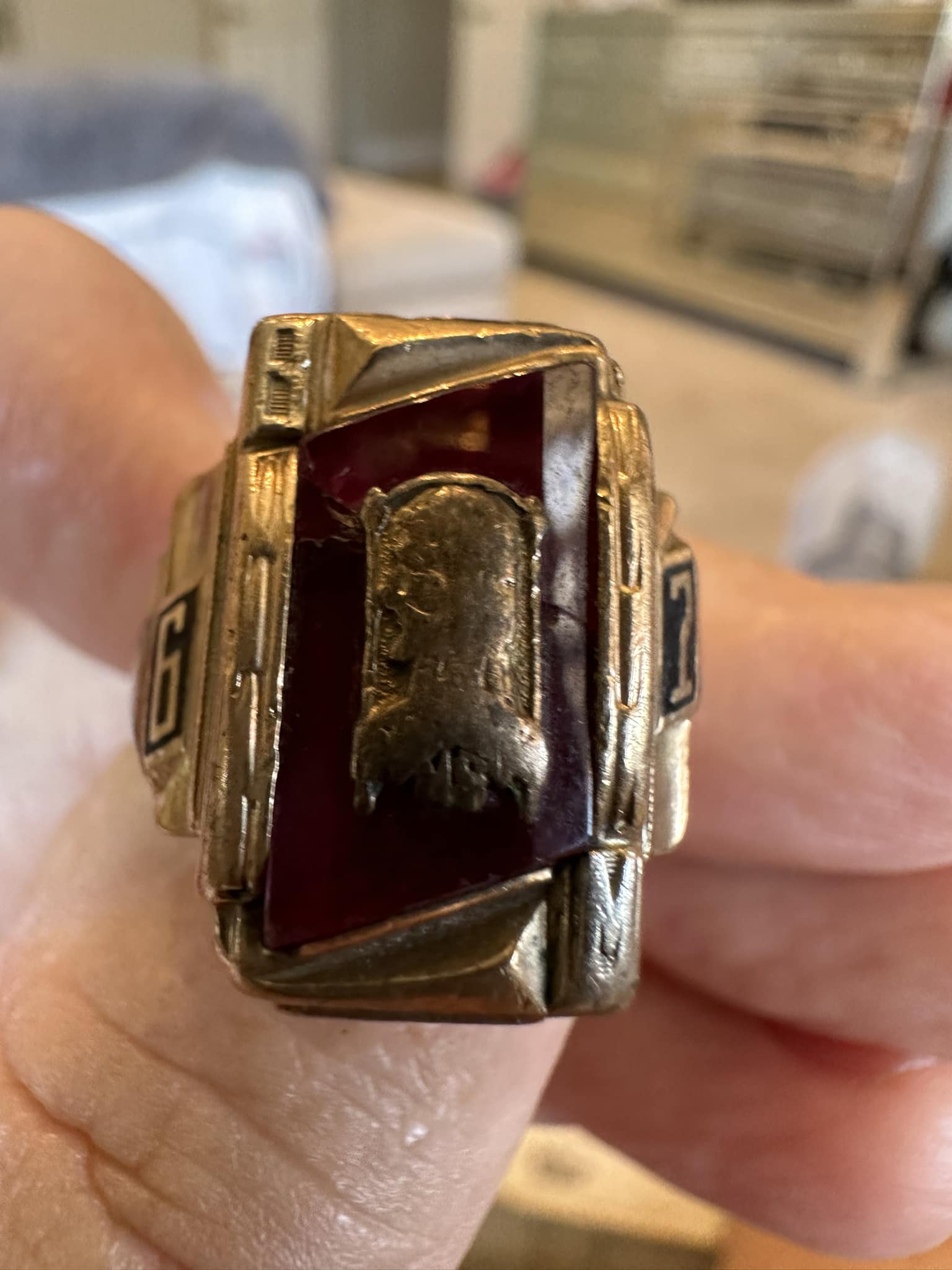 Class of 1967 school ring on small finger