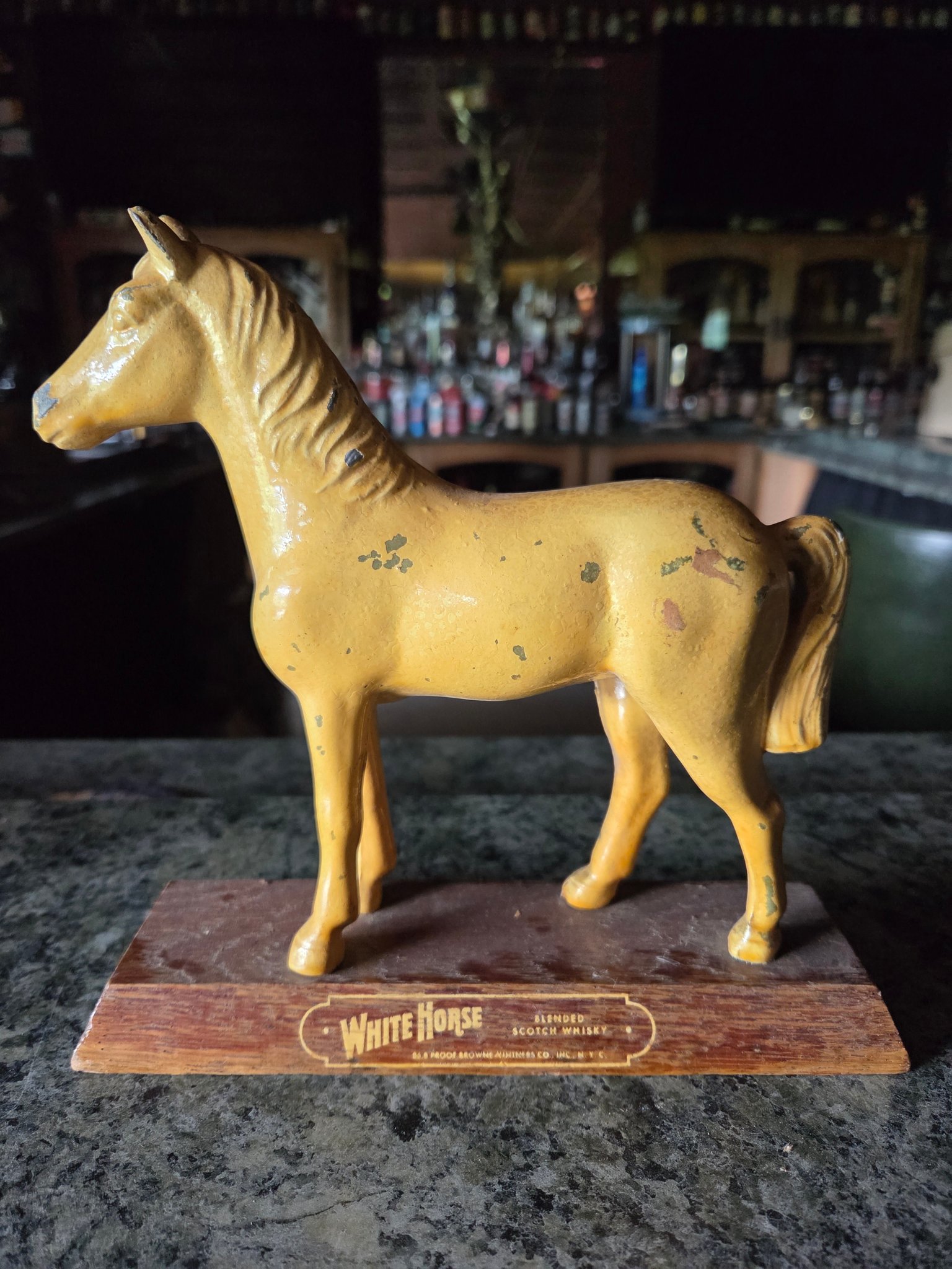 A rare early original collectible figure branded 'White Horse