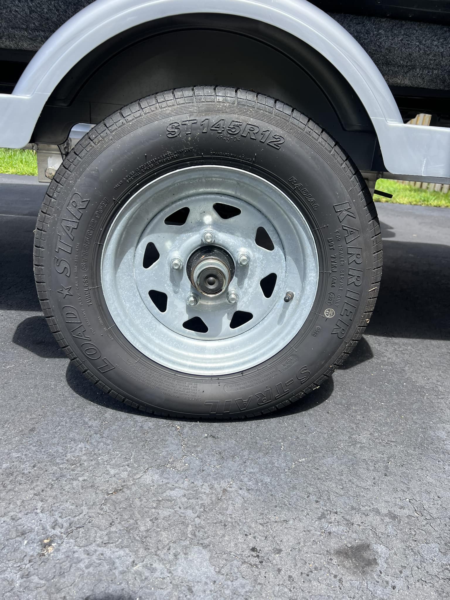 ST145/R12 Loadstar Trailer Tire LRE on 5 Bolt Silver Spoke Wheel