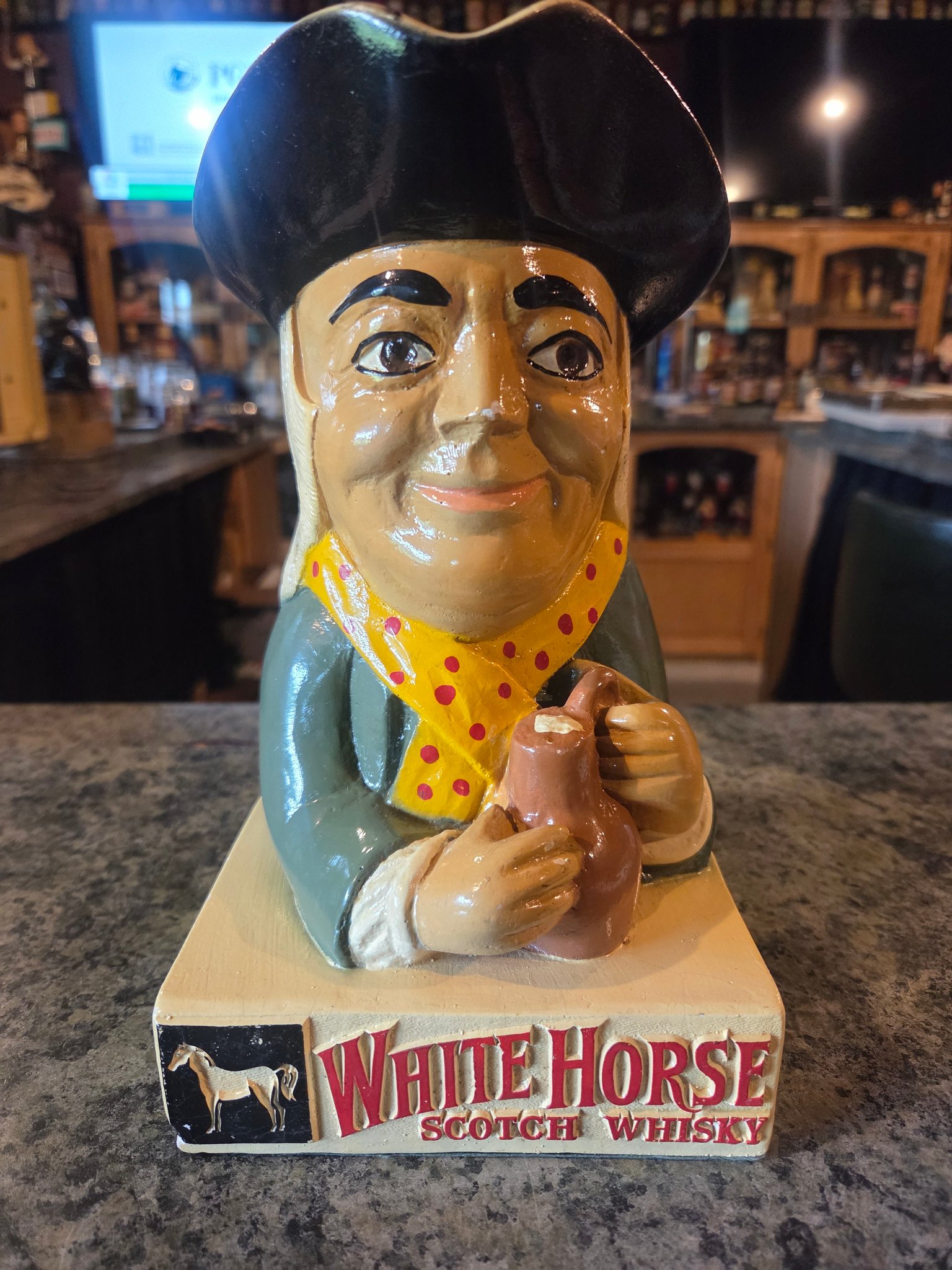 A rare early original collectible figure branded 'White Horse