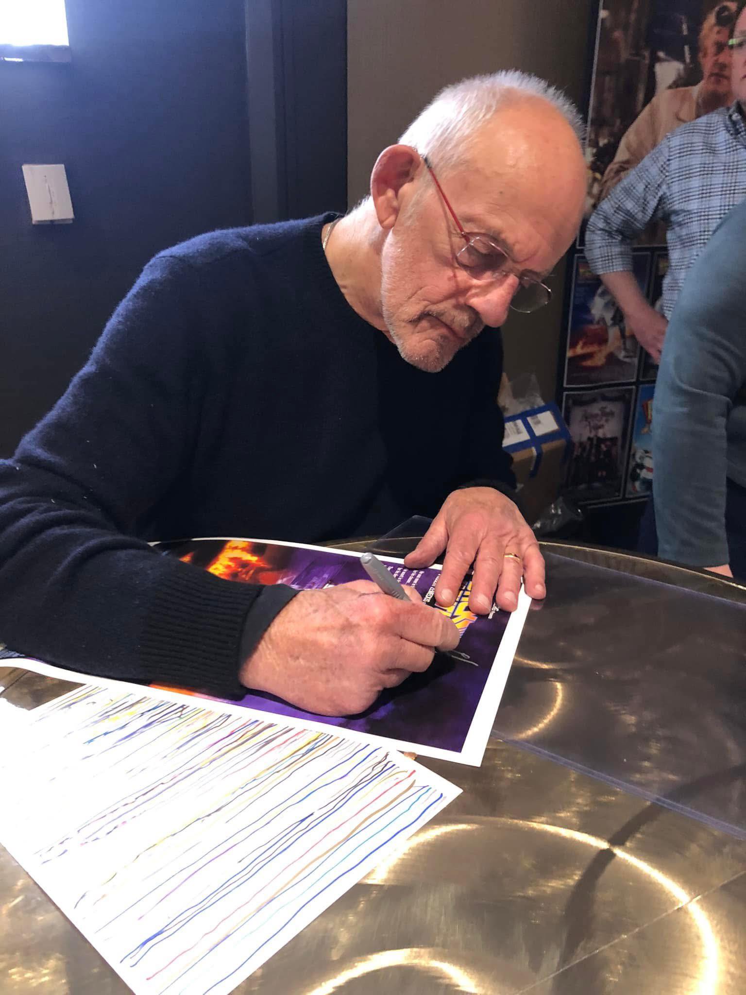 Christopher Lloyd signs Back to the Future poster at Chiller Theatre