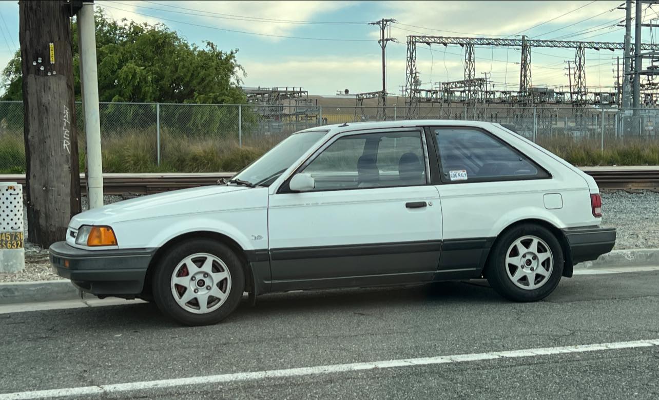 Man, what's this cherry little Mazda Familia 323 doing here by