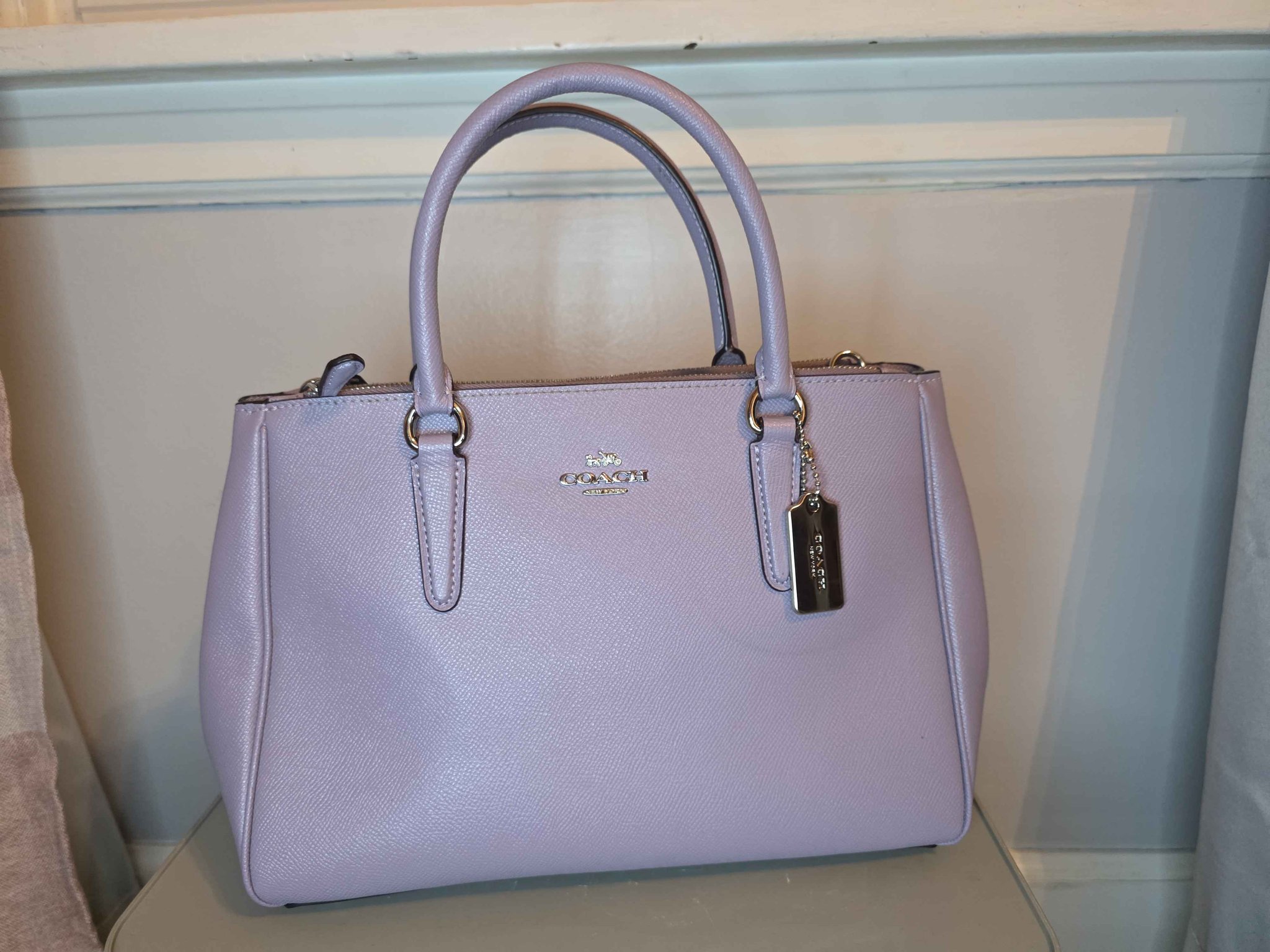 Stylish Coach tote with olive and metallic gold accents. Perfect 