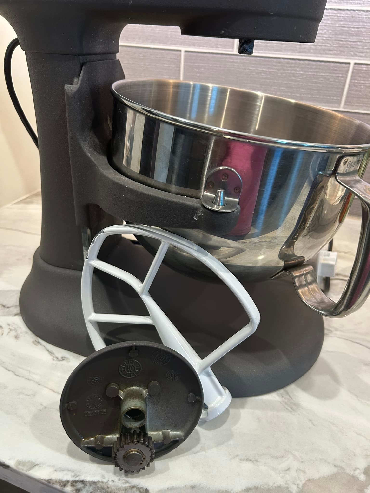 Why does the gear on my KitchenAid mixer keep falling out?