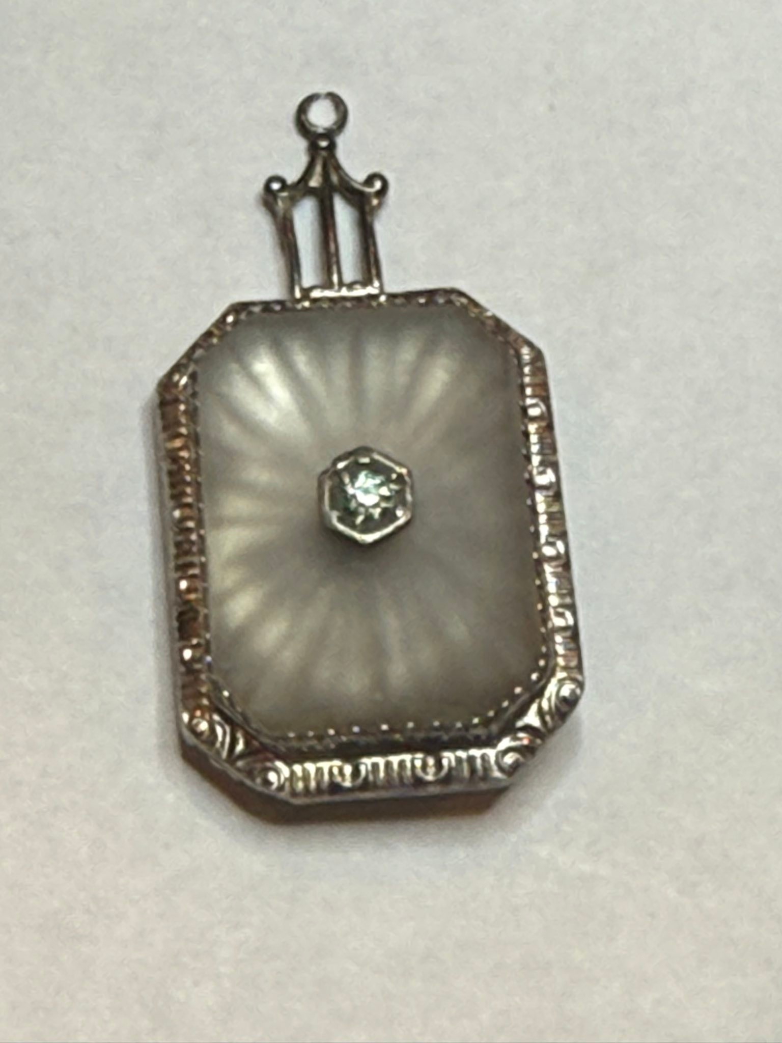 What is camphor glass with caged coin pendant?
