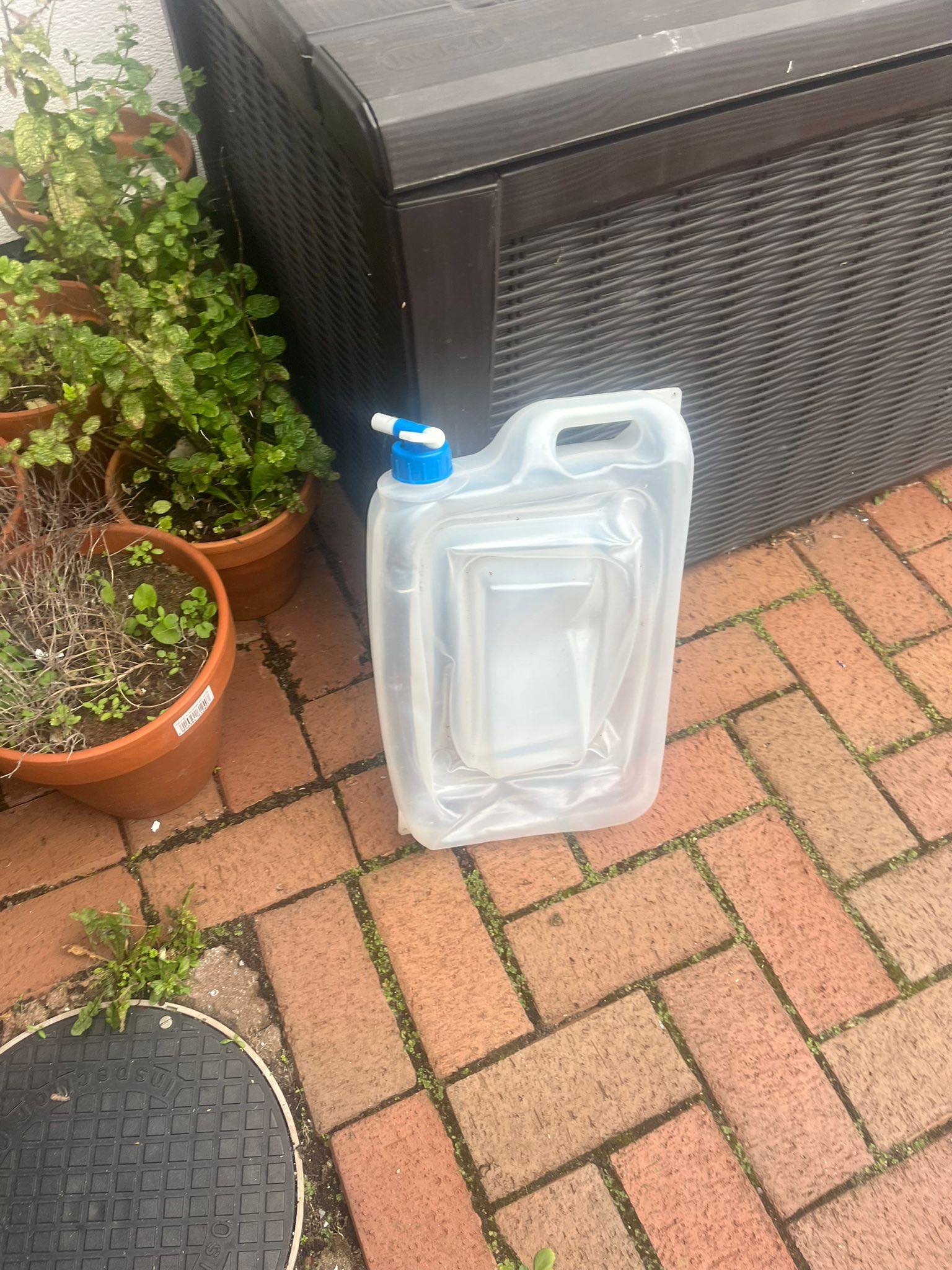 Collapsible water carrier for camping plus a vintage folding small 