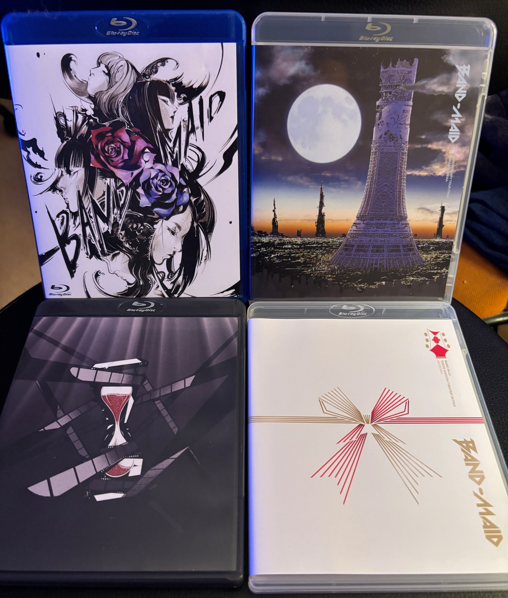 BAND-MAID Blu-ray collection displayed with various covers