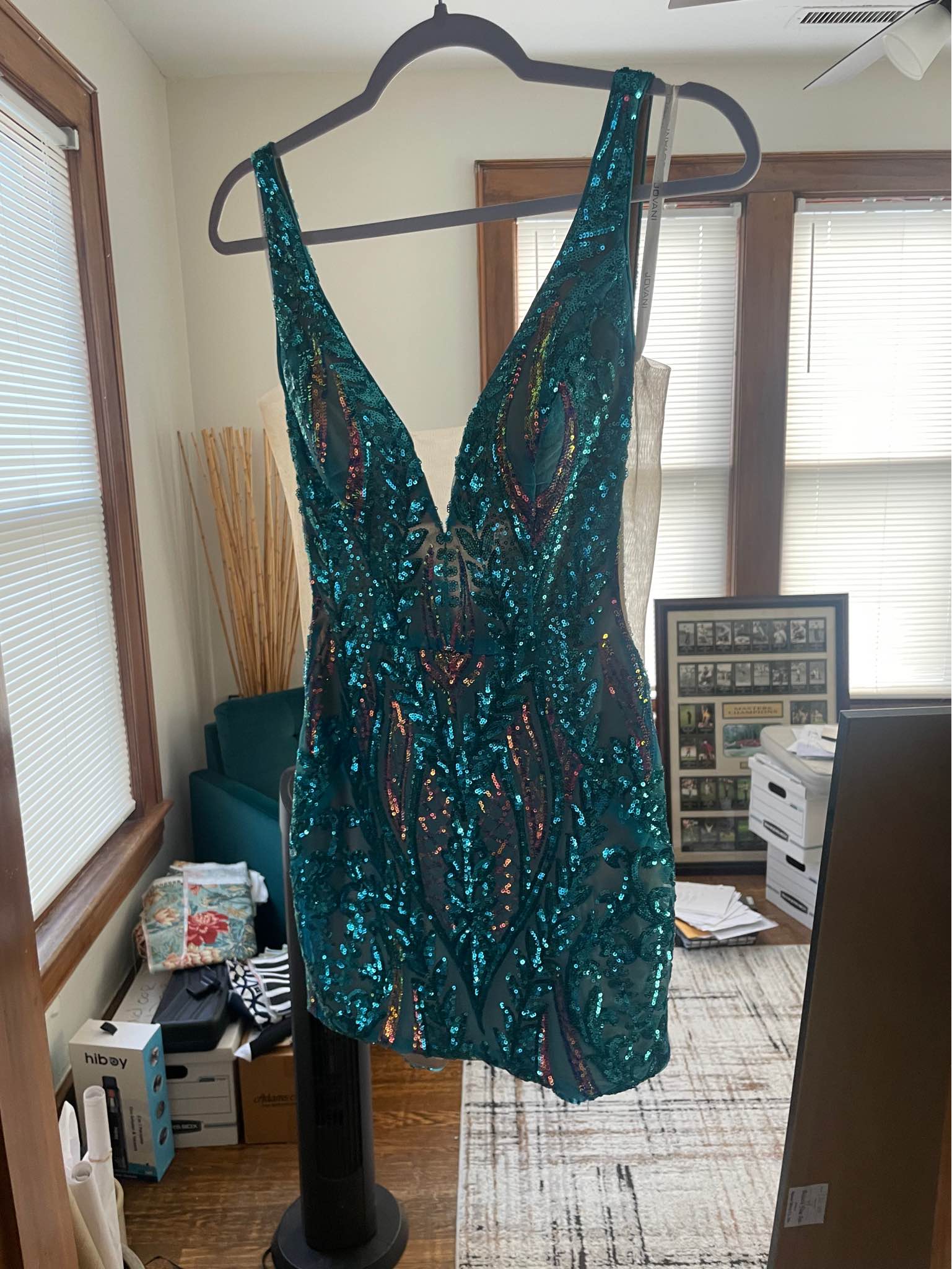 emerald green sequin lace frill hem bodycon dress Stunning teal Jovani cocktail with iridescent sequins. This sleeveless garment has a deep V-neckline and a fitted silhouette. The dress is constructed with a mesh overlay featuring intricate patterns in 93% Polyester Color:Silver stones with gold Womens dresses 3m-12m Short Sleeve Open Back