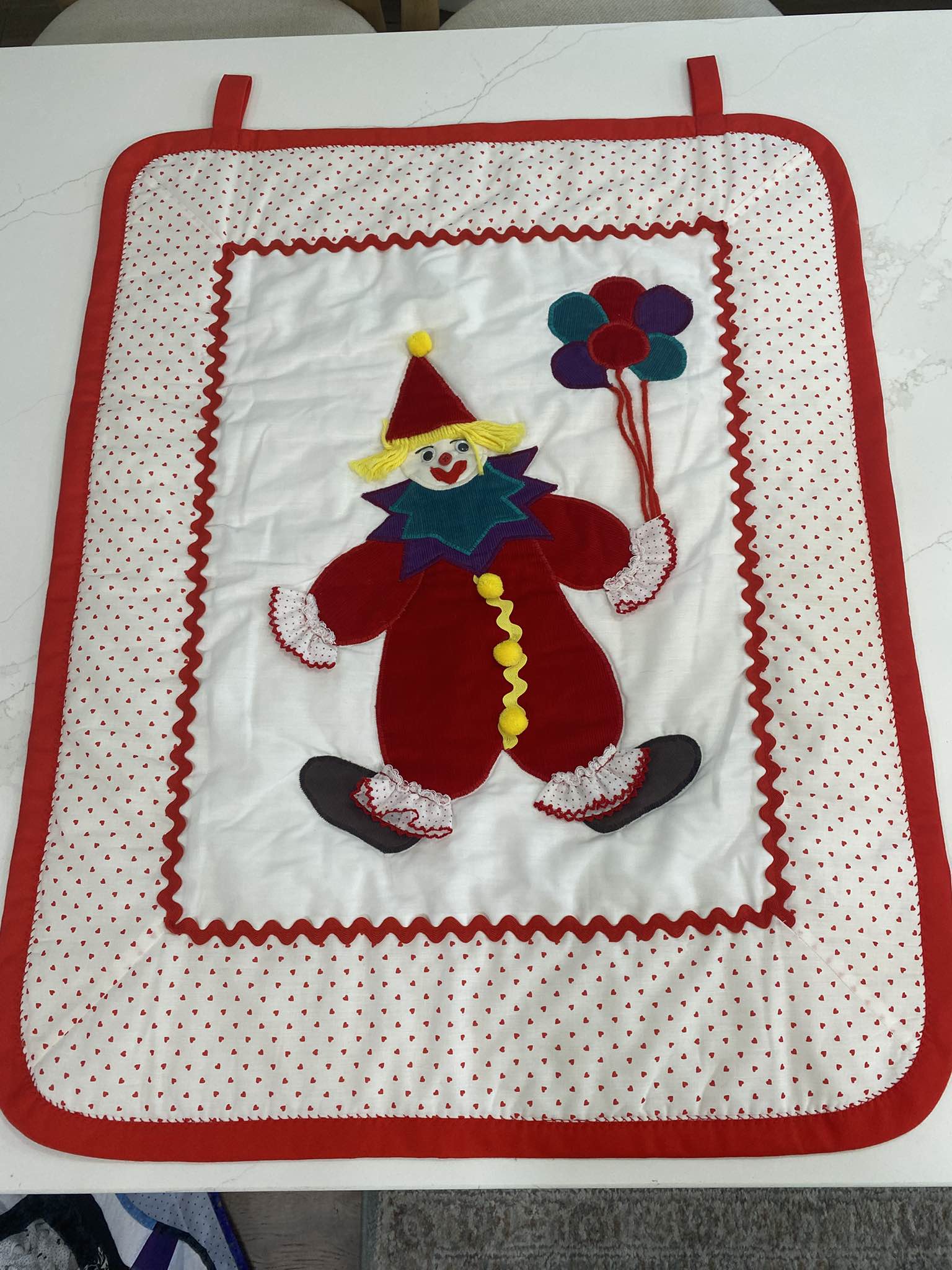 Handmade vintage clown wall hanging quilt features a central