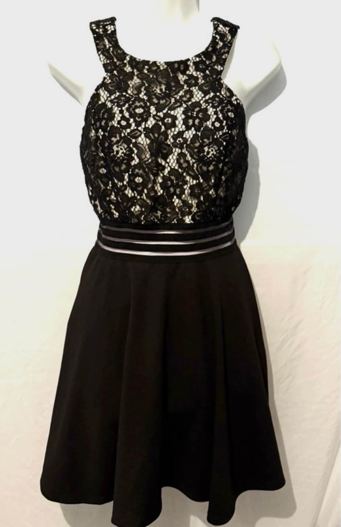 speechless homecoming dresses Women's Size 9 black lace dress. It features a high halter-style neckline, an overlay bodice of intricate black floral lace layered over a contrasting light tan or nude lining, and dresses - maxi length