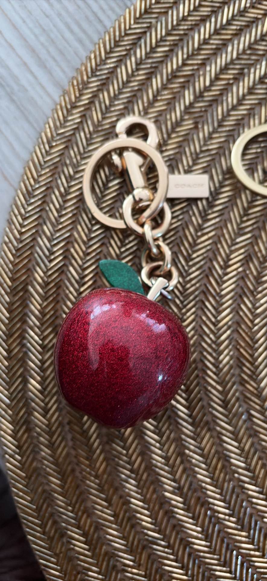 Sparkling red glitter apple keychain with gold-tone hardware. This