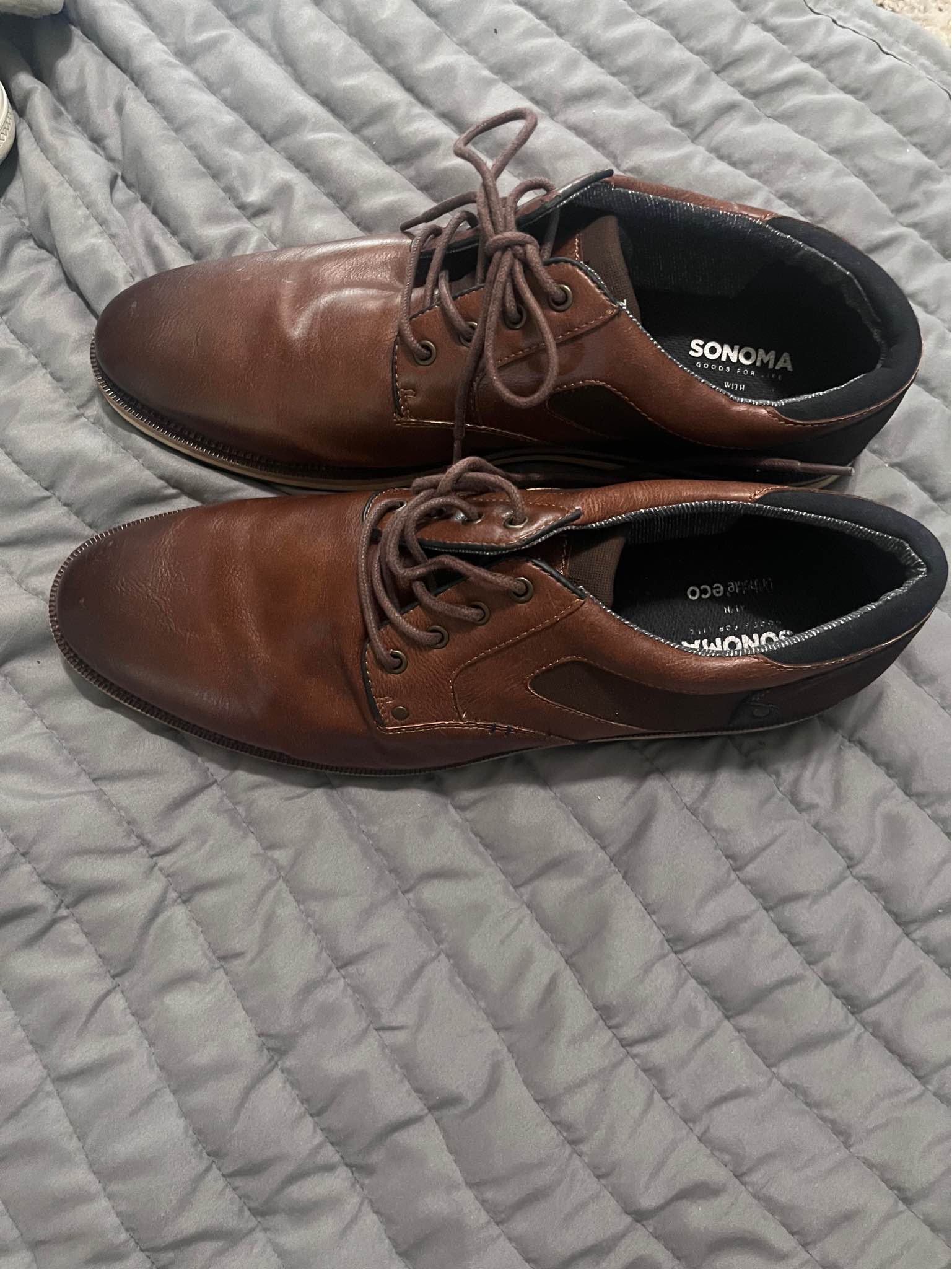 Stylish brown faux-leather dress shoes from Sonoma Goods for Life. These shoes have a lace-up closure, dark brown fabric accents on the sides, and a contrasting light-colored sole. The interior features Ortholite