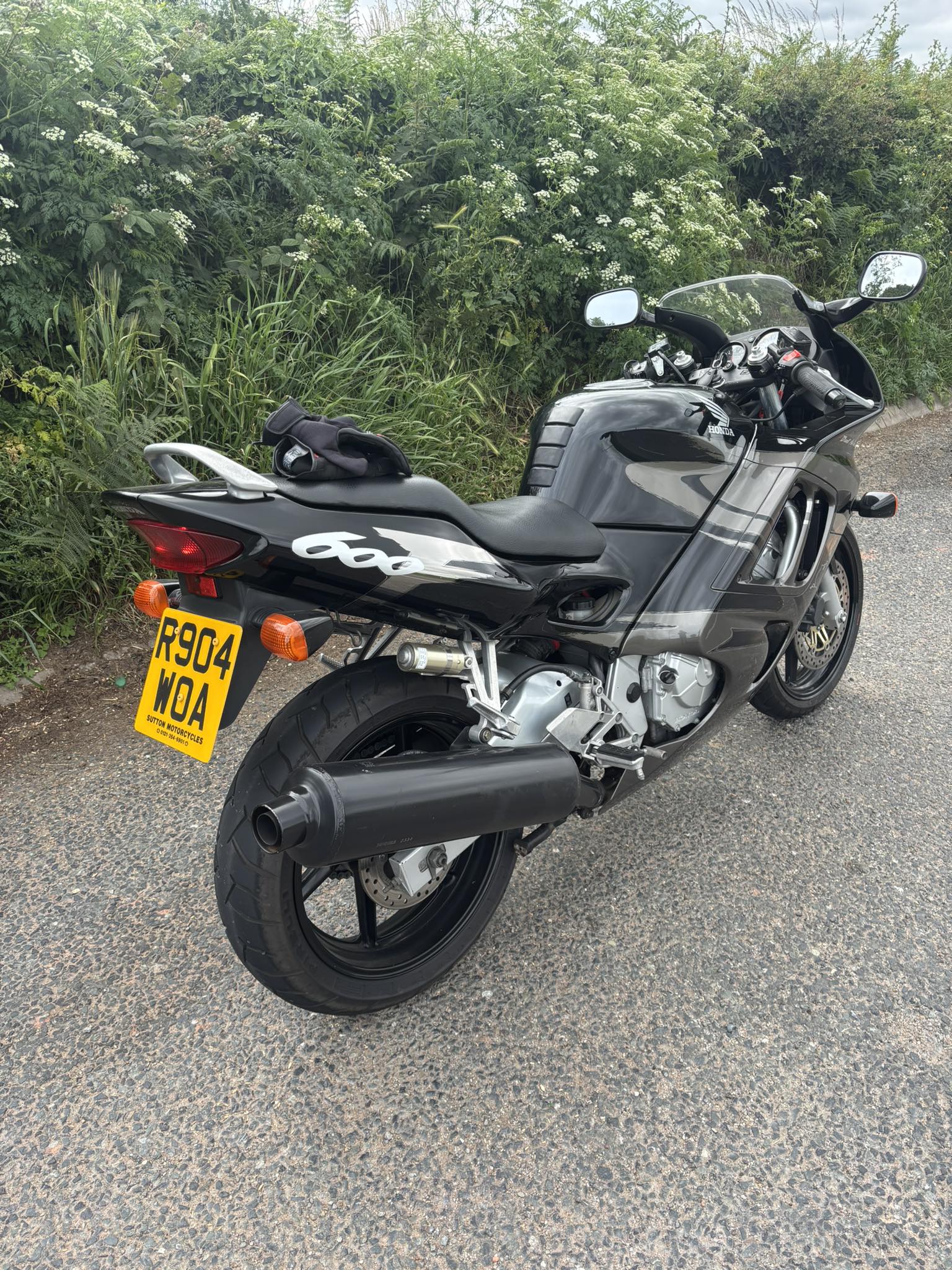 New slip-on exhaust on yellow Honda motorcycle | Ponoka, AB