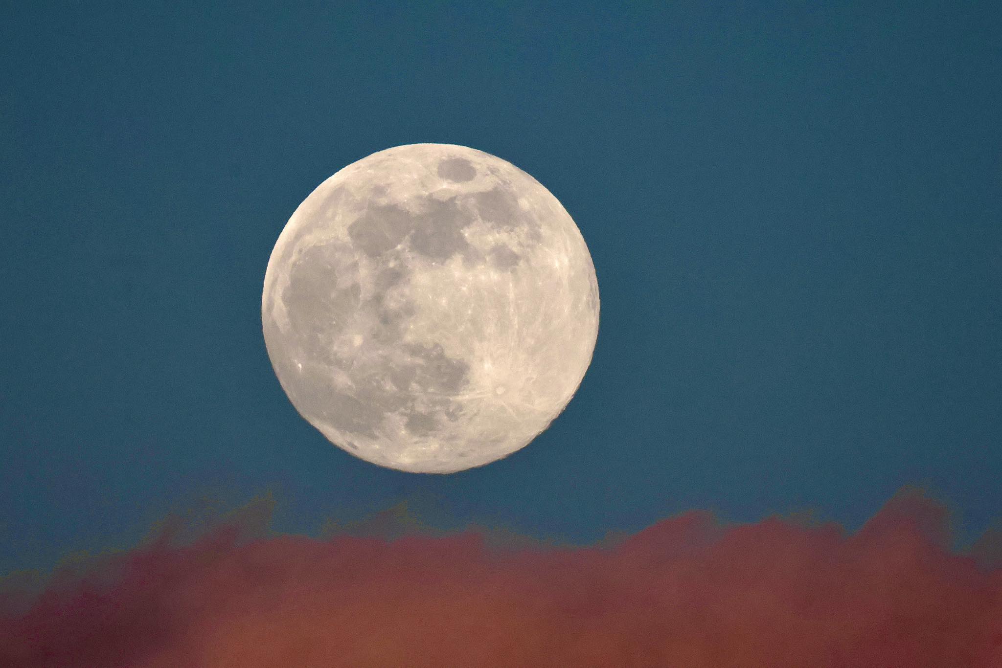 1st full moon of 2026 over the Sandia Peak, in clouds