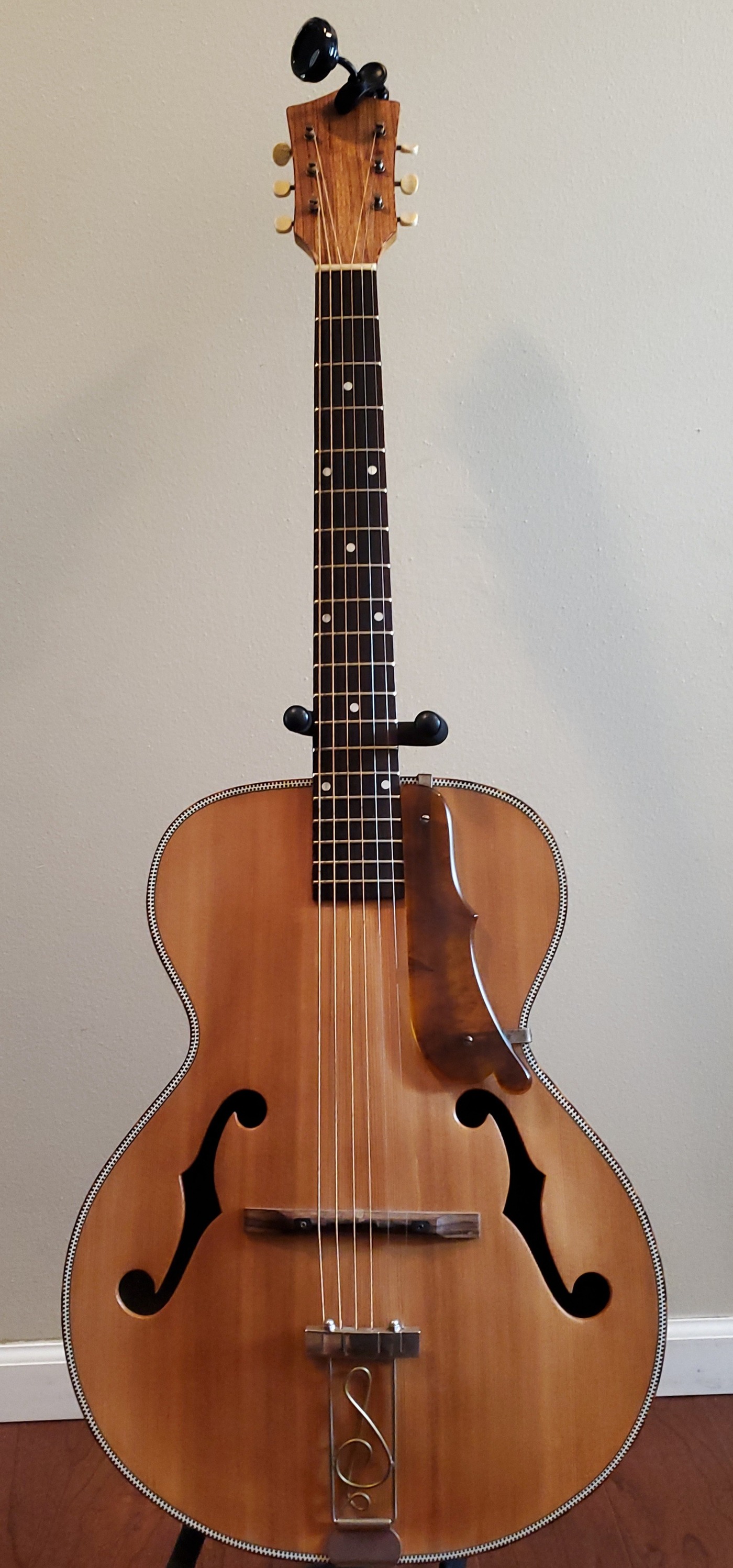 What is this vintage guitar with unique music note design?