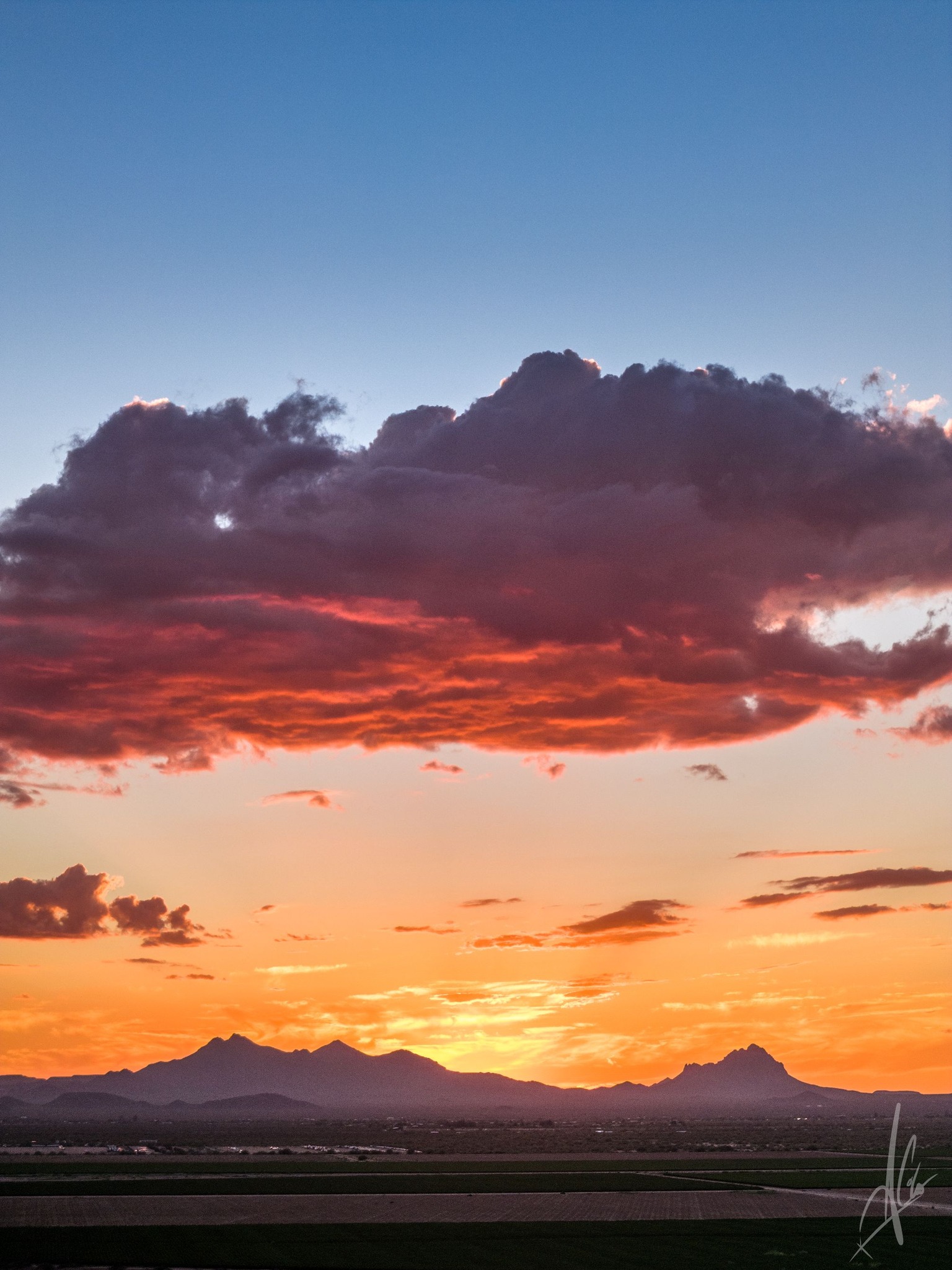 Breathtaking sunset over Avra Valley, AZ with Ragged Top and