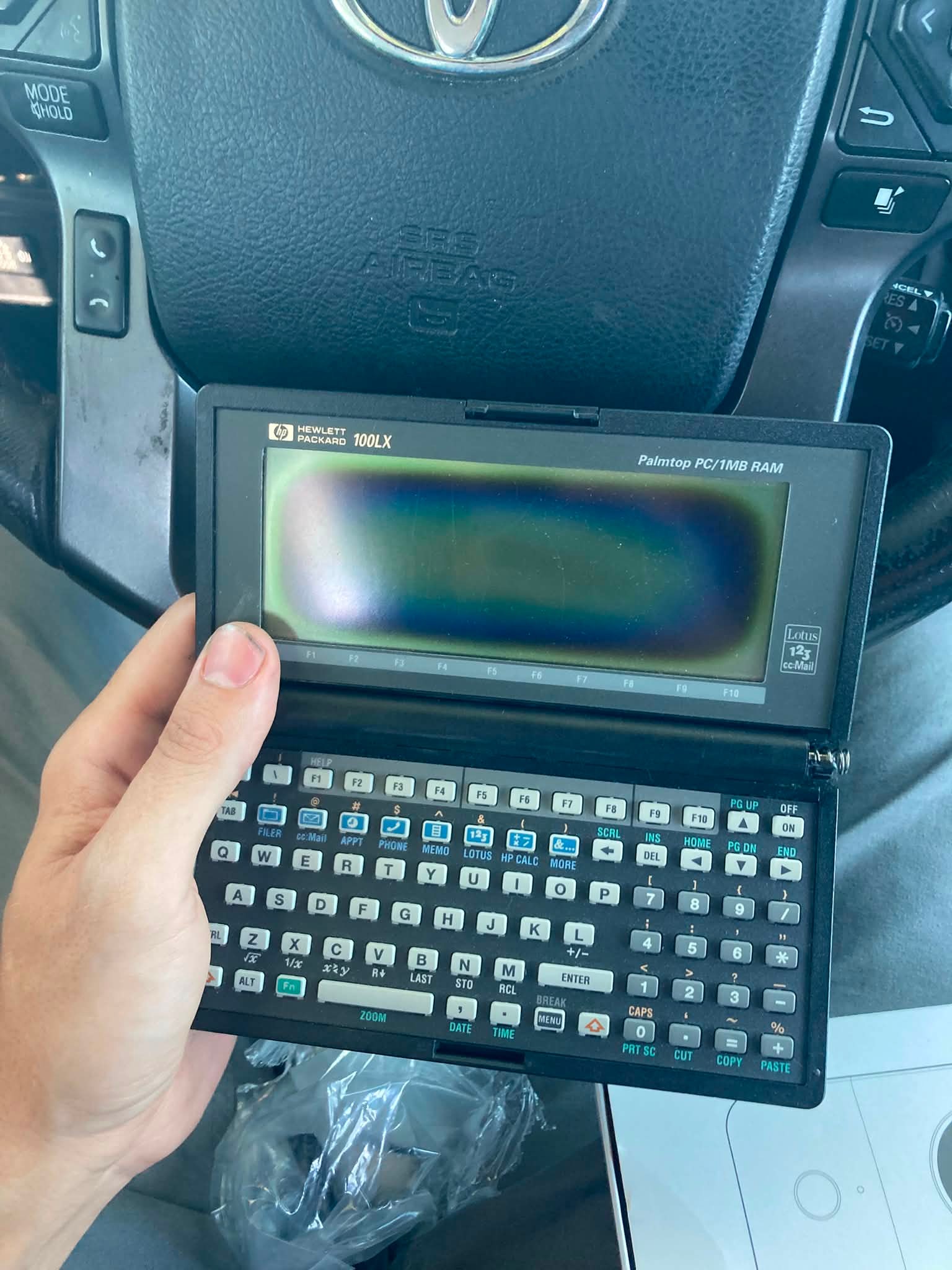 What are the specs and features of the HP 100LX Palmtop PC?