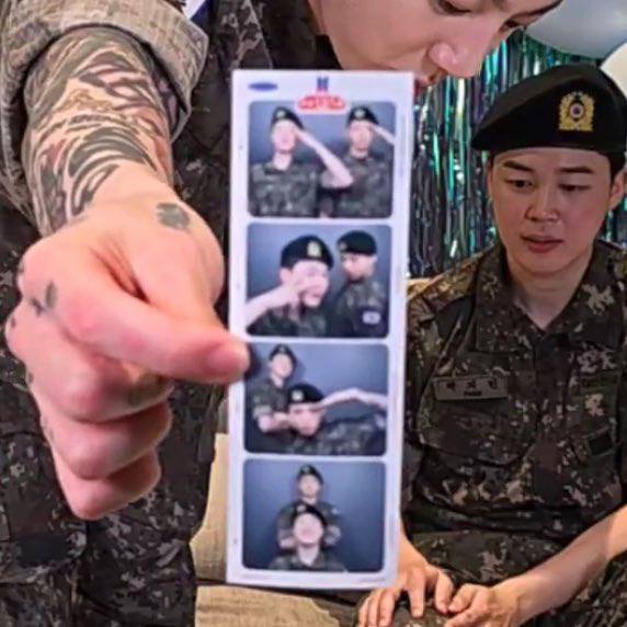 Jungkook showing their photos with Jimin from the FESTA photobooth