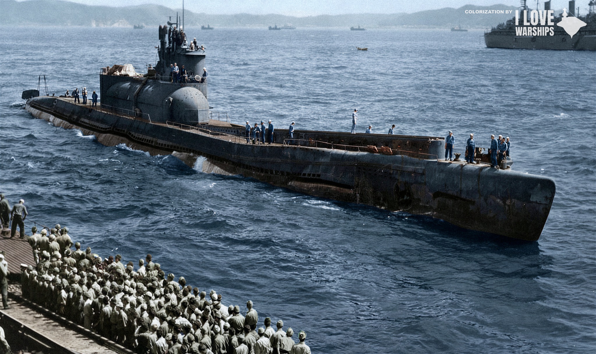 The captured Imperial Japanese Navy submarine I-401 passes a crowd