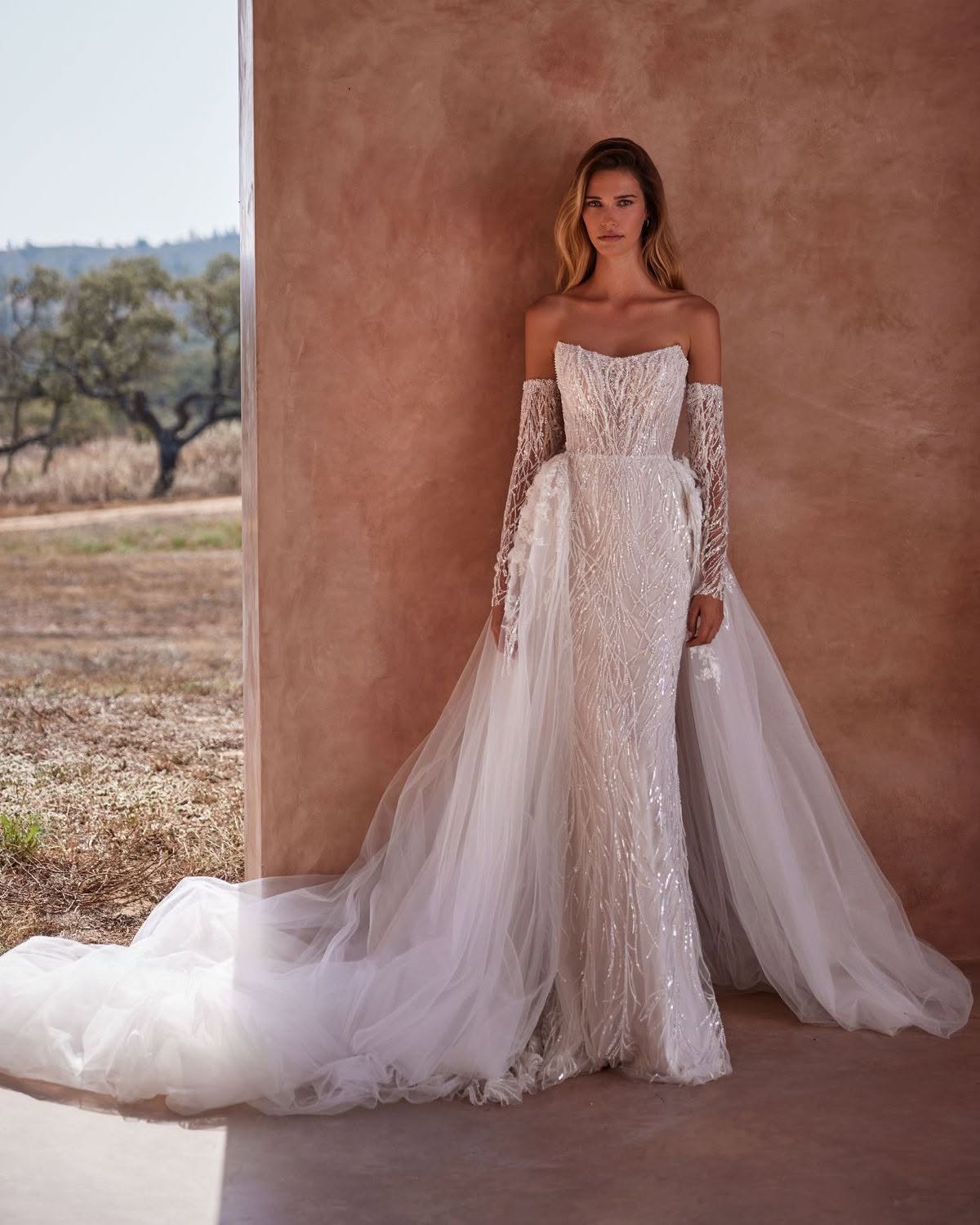 VENUS Dress✨! Drenched in delicate sparkle, this breathtaking #MillaNova wedding dress features shimmering sequins, intricate beading, and lustrous pearls for a touch of timeless elegance. The dreamy puffy tulle overskirt, adorned with