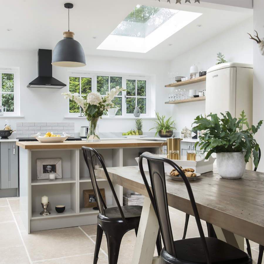 Image showcasing Ideal Home - The absence of wall cabinets in this kitchen achieves a ...