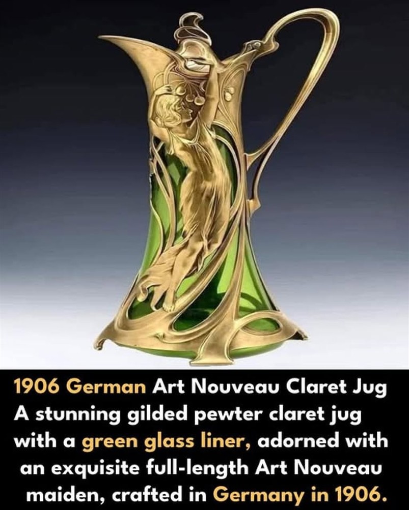 WMF Gilded pewter claret jug with a green glass liner and maiden