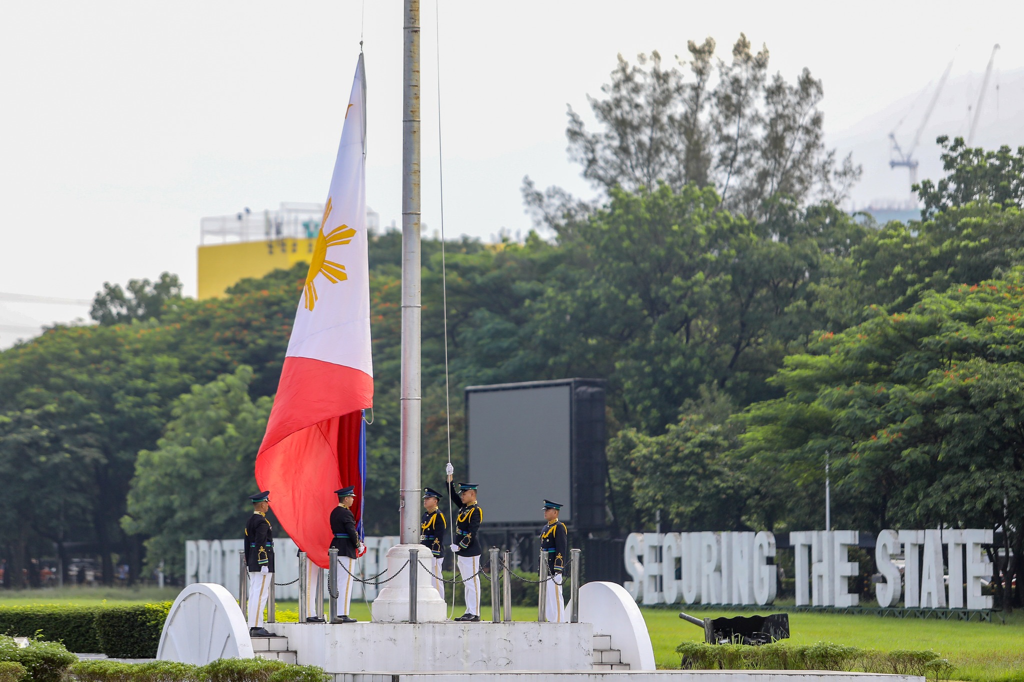 Armed - AFP personnel raise the Philippine flag during the ceremony ...