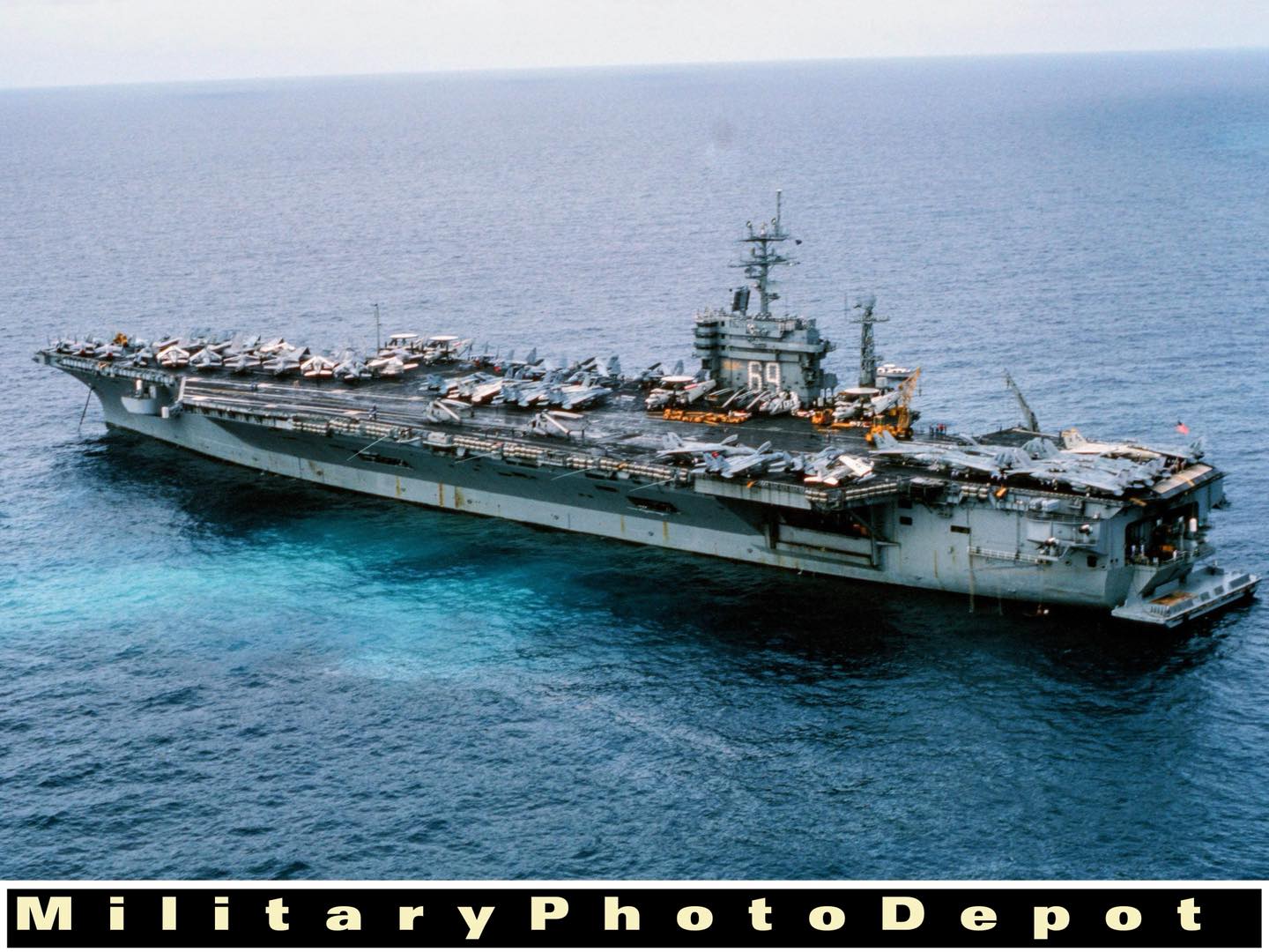 An elevated port bow view of the nuclear-powered aircraft carrier