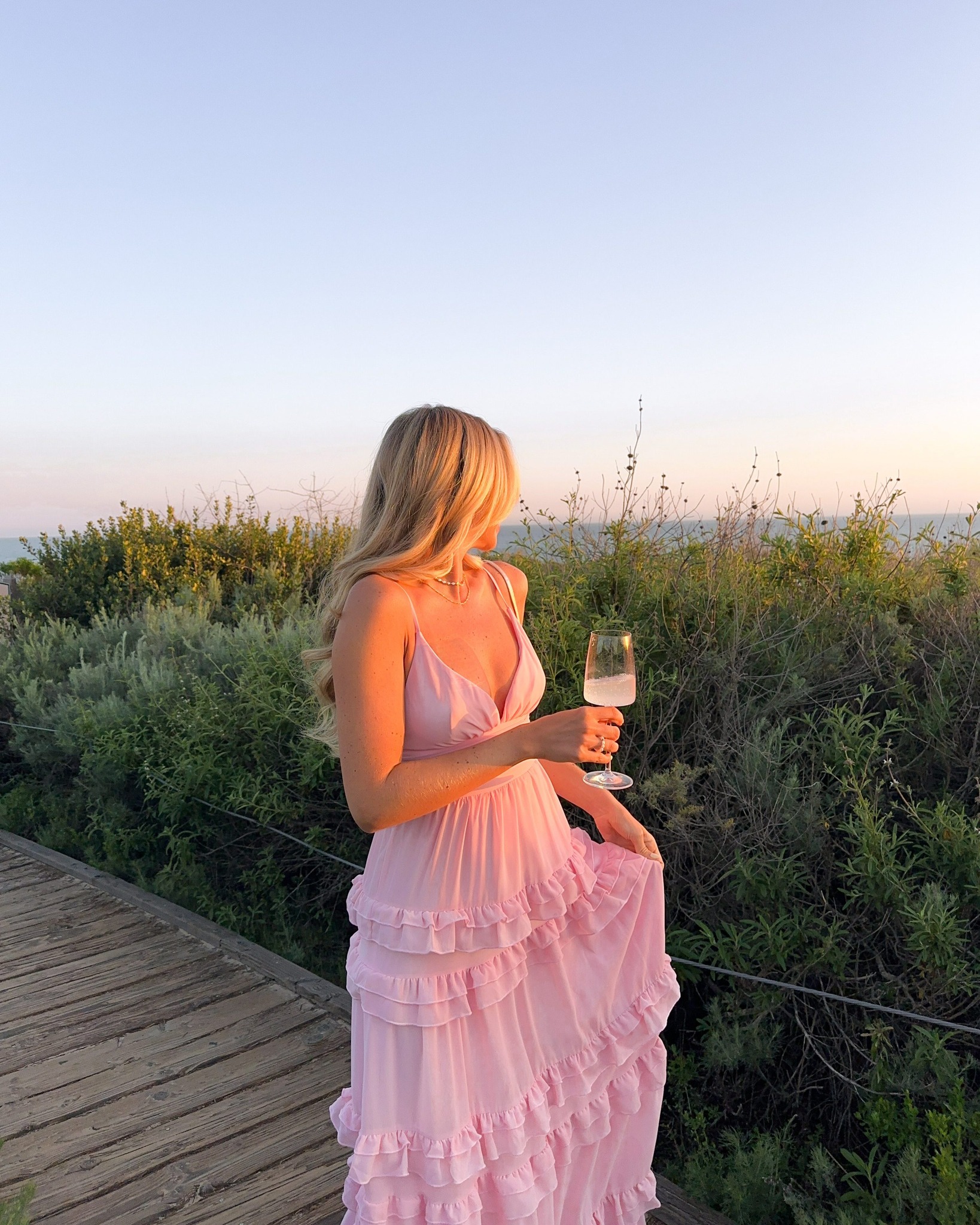 flowy sunset dress spotted at sunset: the dreamiest and view on @solarpowered_blonde 💖🌅 shop her look for your coastal events here: lulus.visitlink.me/t7ODiV ✨ #lovelulus VOGA30