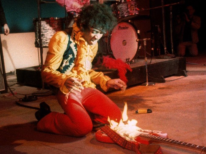 Jimi Hendrix lighting his guitar on fire at the Monterey Pop