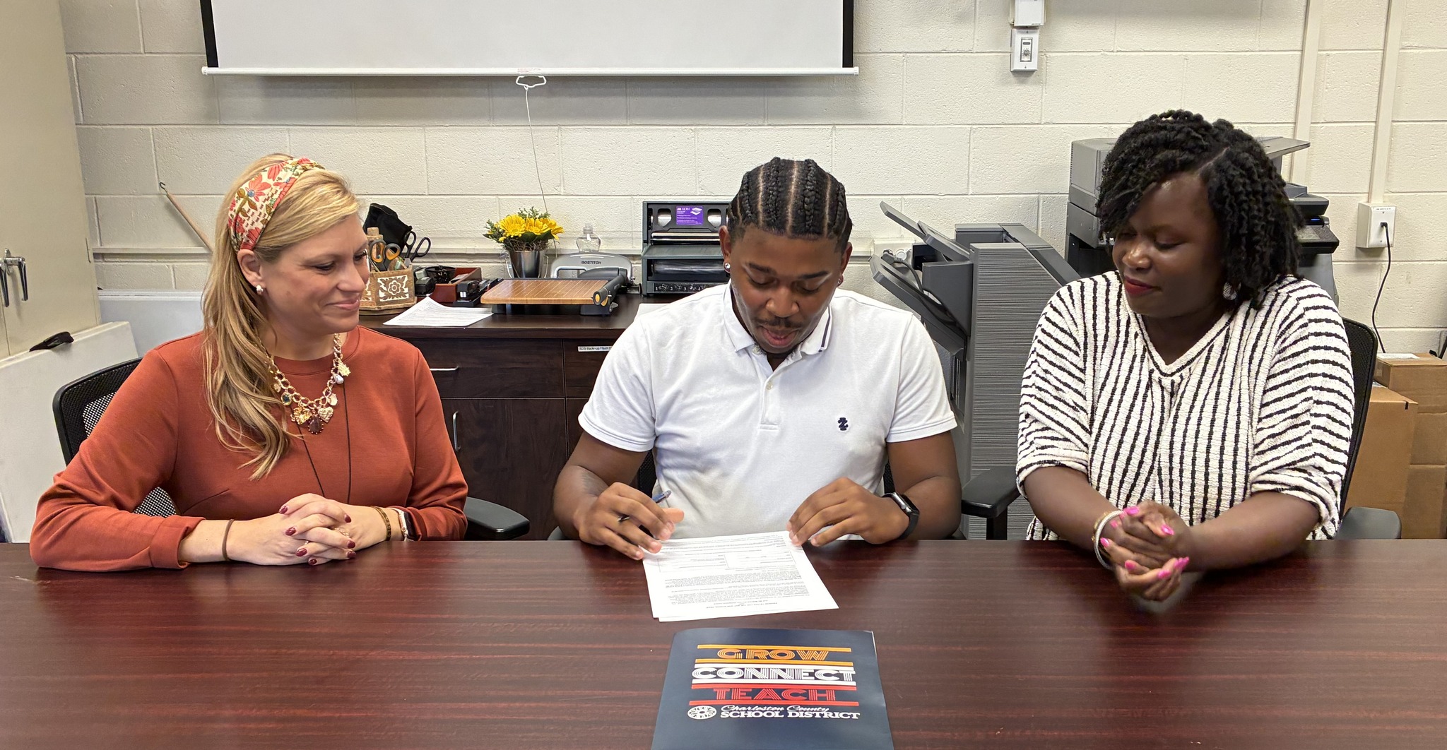 CSU-College - Damontae preparing to sign his contract. Also pictured ...