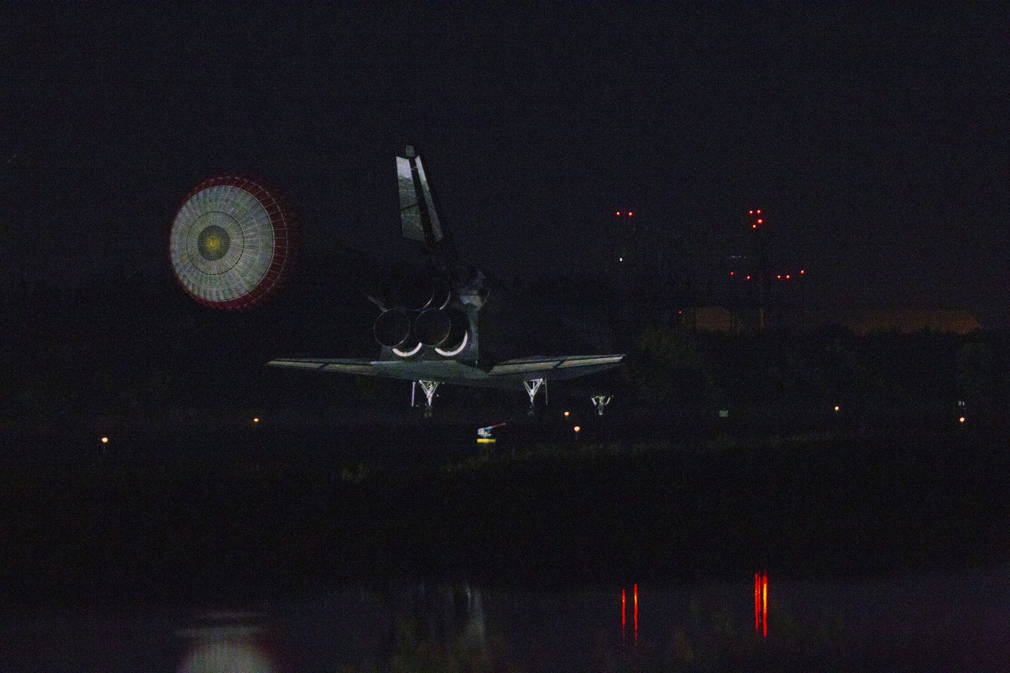 Blast - Space shuttle Atlantis' drag chute slows the shuttle as it ...
