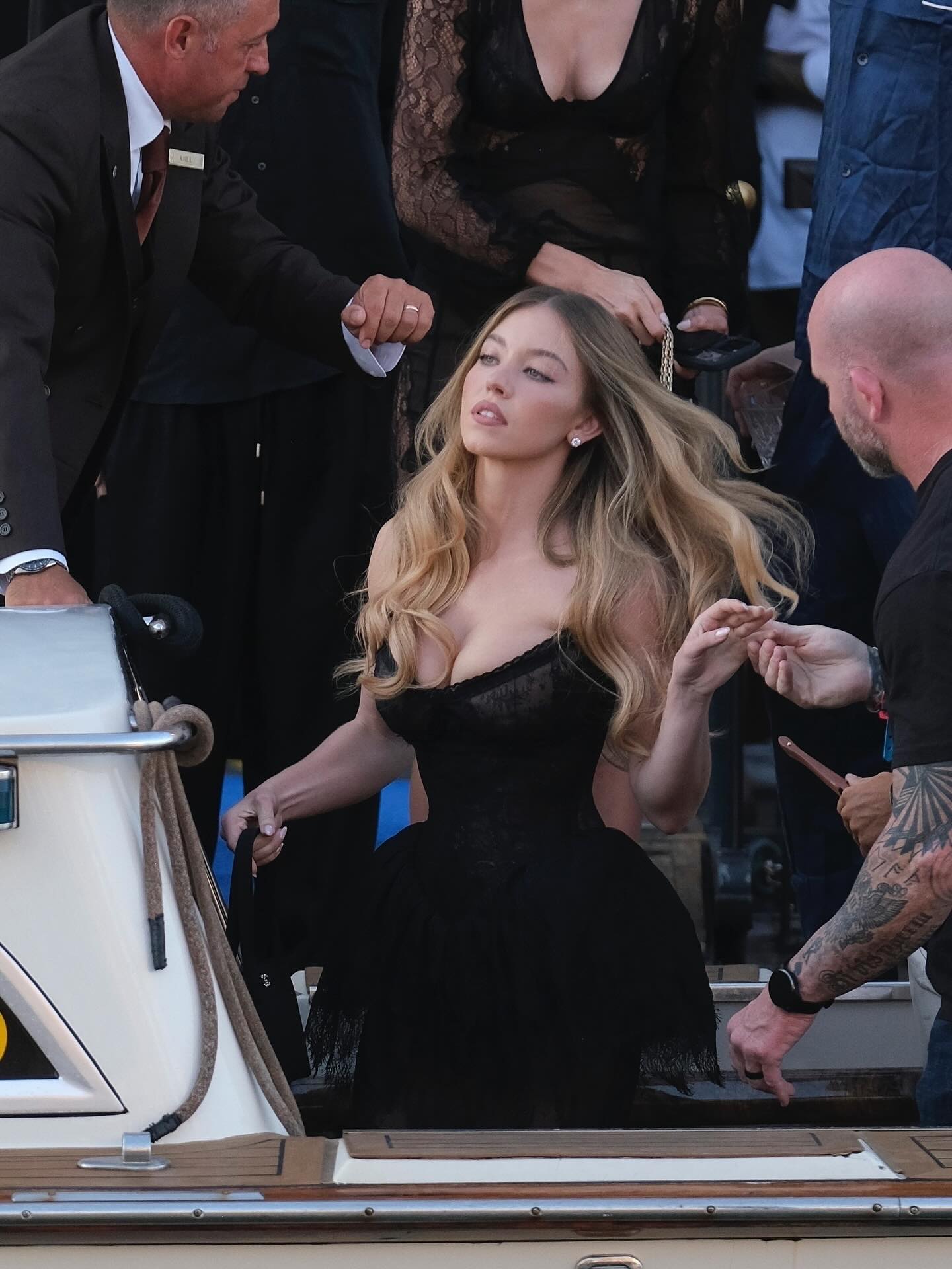 sydney sweeney in black dress wears a sheer look while heading out to Jeff Bezos and Lauren Sanchez's Dolce Notte party Venice. See more at JustJared.com! # SydneySweeney Photos: Backgrid Jacket Length:Regular