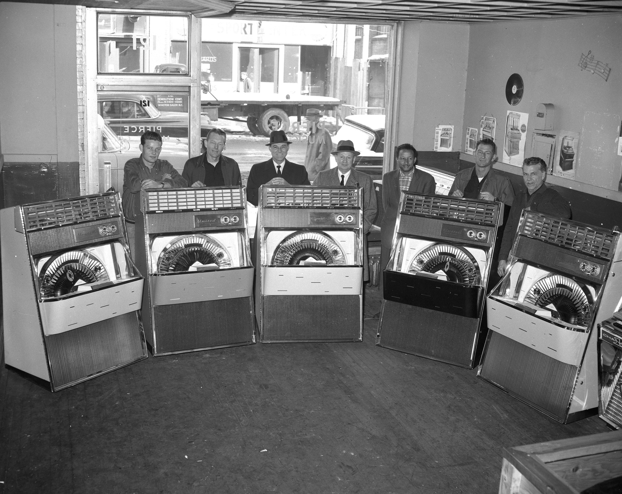 Olde - Pierce Music Company employees pose with new line of 