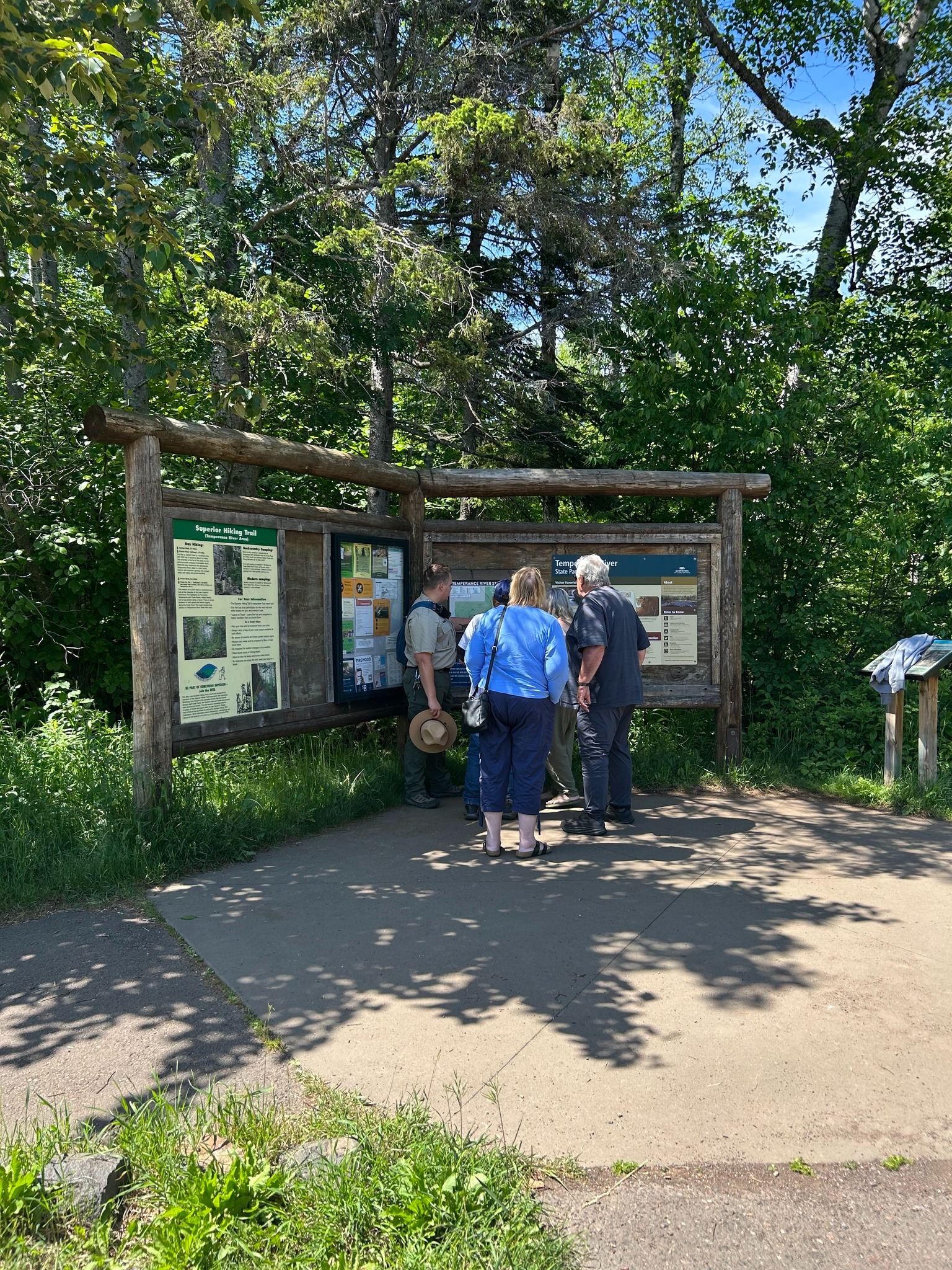 Minnesota - A park ranger speaks with visitors at an information kiosk ...