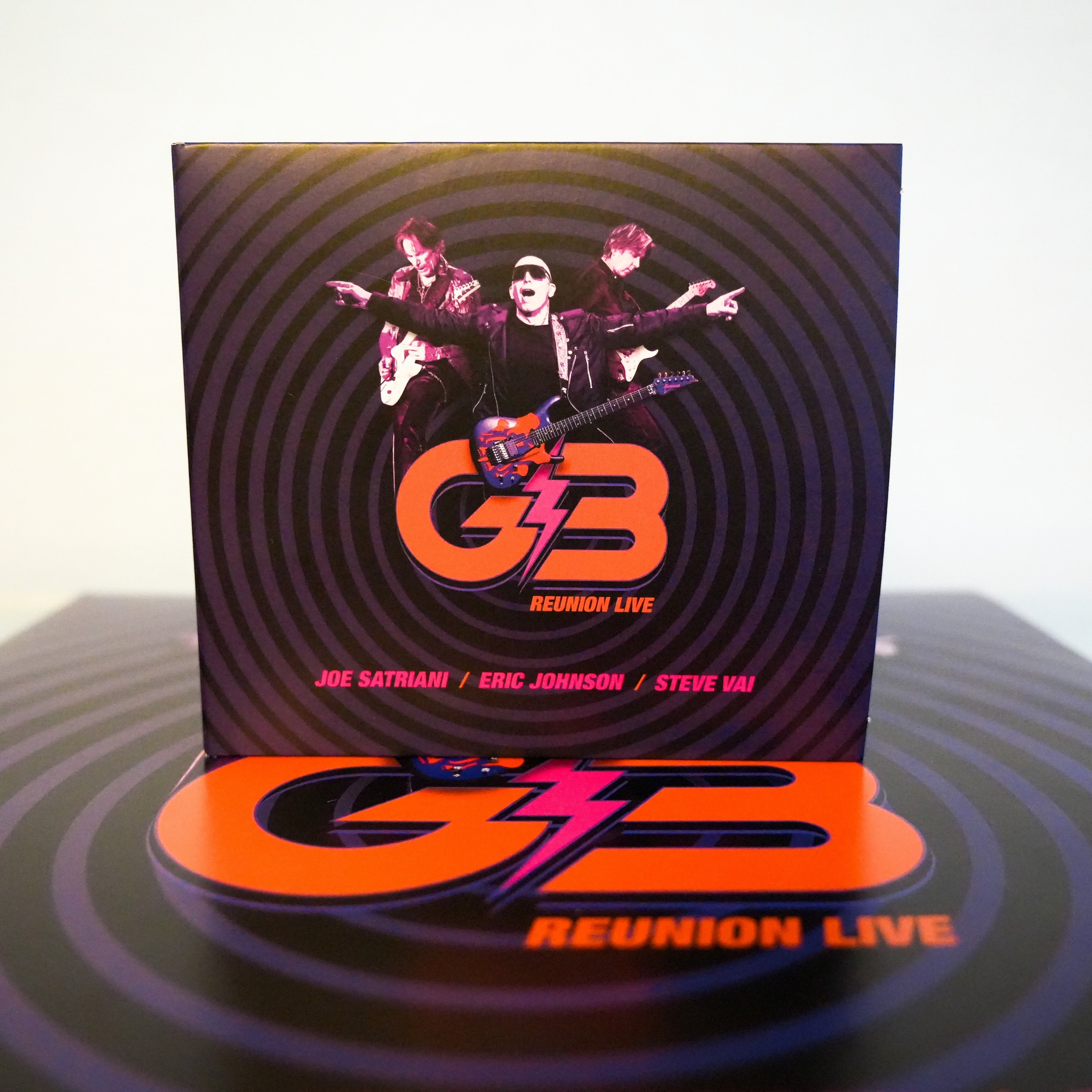 The G3 Reunion Live 2-CD set, including a 24-page photo booklet