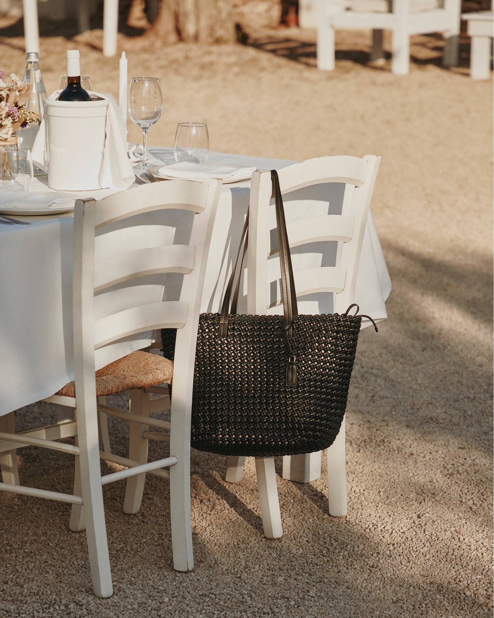 Soft sunlight, a table set for two, and a bag woven with the