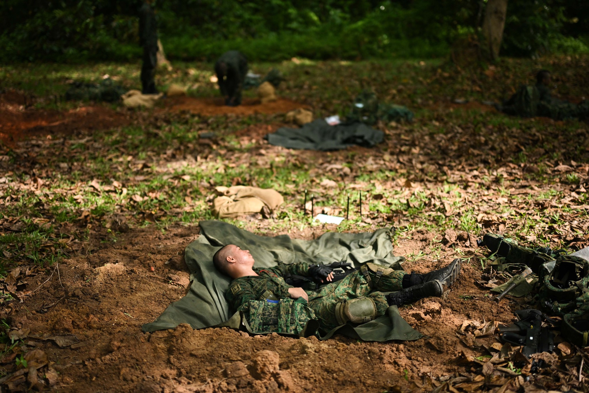 The Straits - A recruit resting inside his shell scrape after digging ...