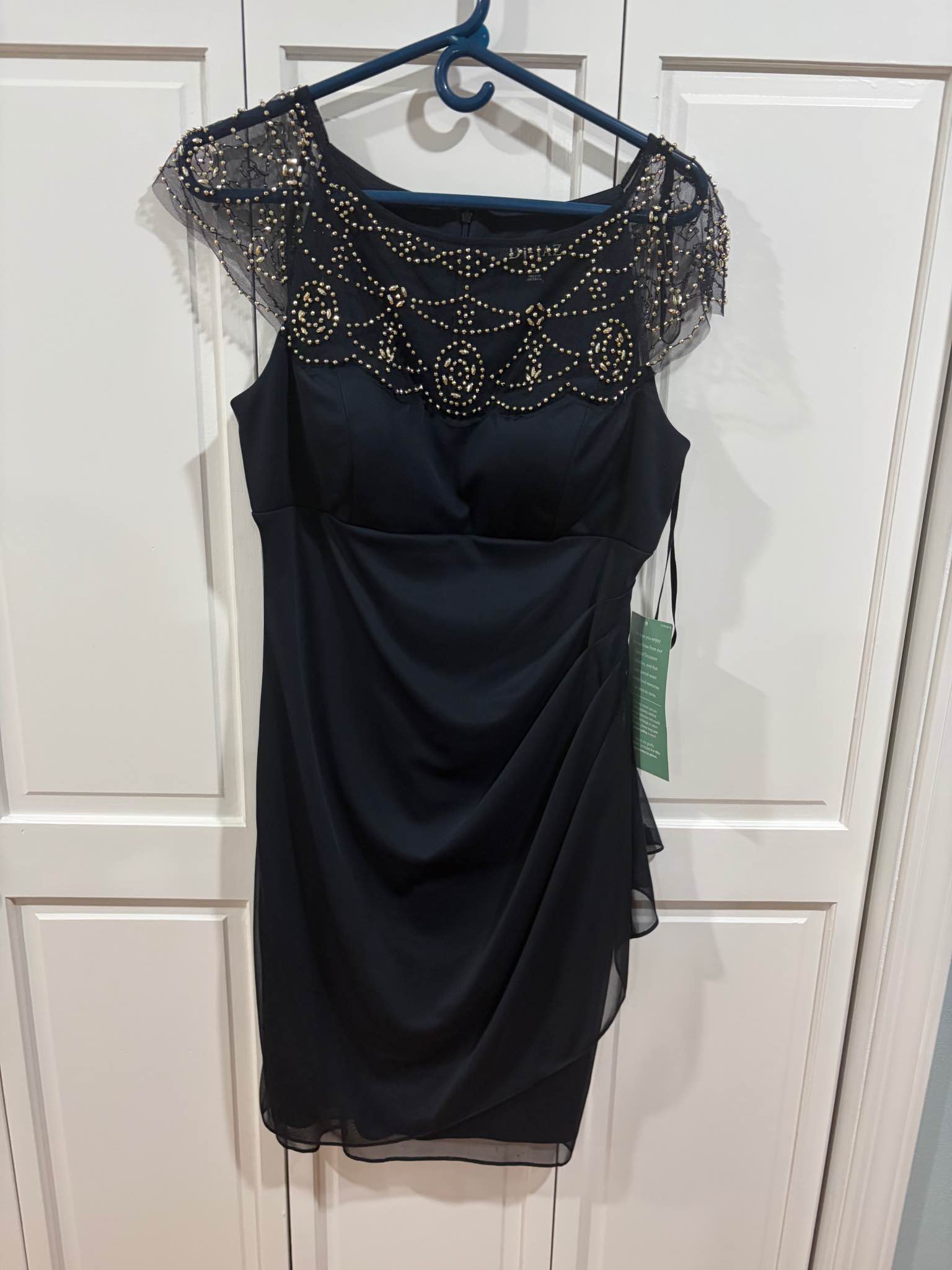 dj jazz cap sleeve beaded neck sheath dress Elegant black cocktail from the Vince Camuto Special Occasion collection. This garment has a mesh neckline and sleeves with gold-tone embellishments. The body is a dark navy or black Made from soft jersey