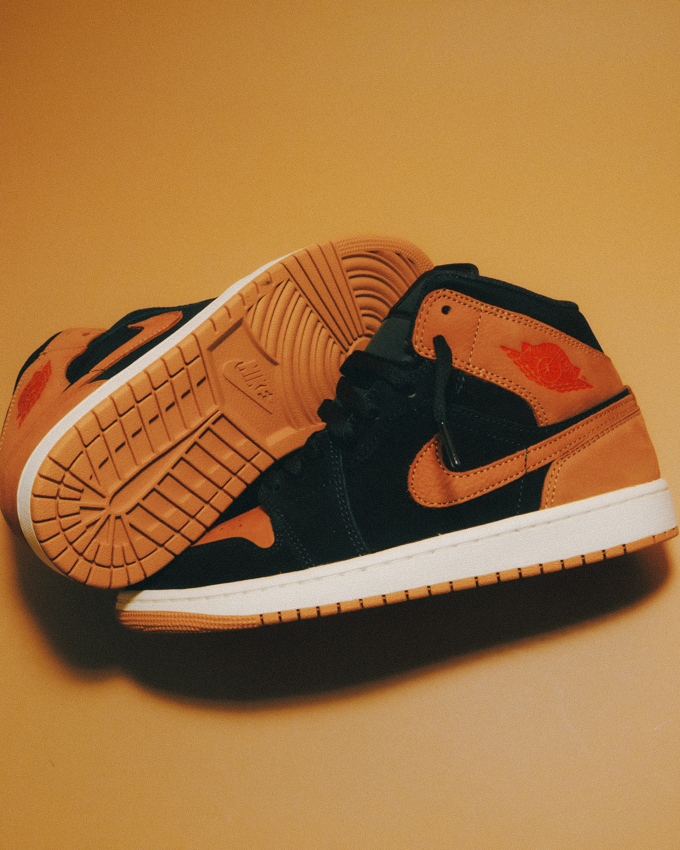 The Air Jordan 1 Mid SE (Black/flax-varsity Red-sail) is available 