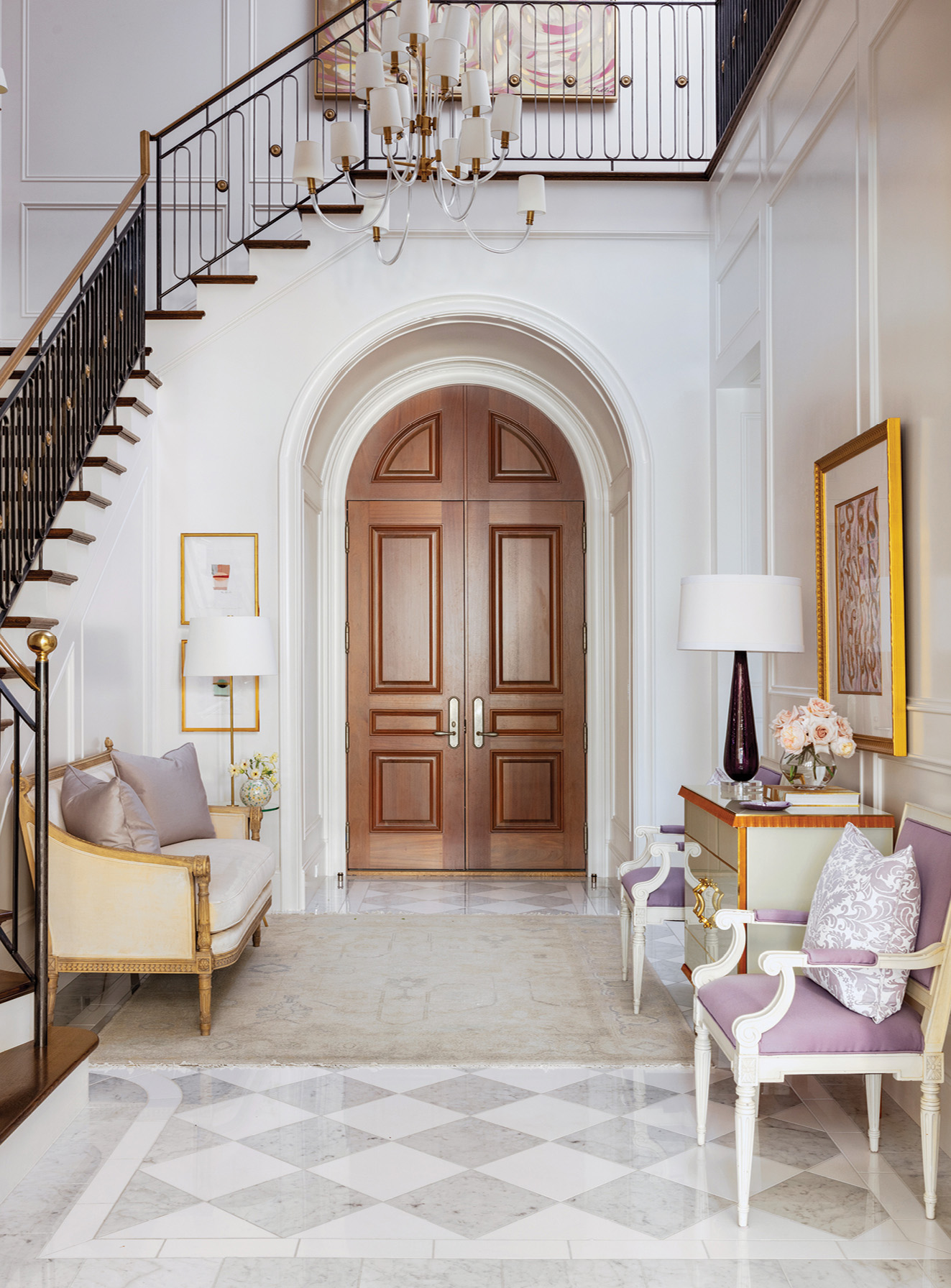Southern - An arched entry, paneled walls, and iron staircase add ...